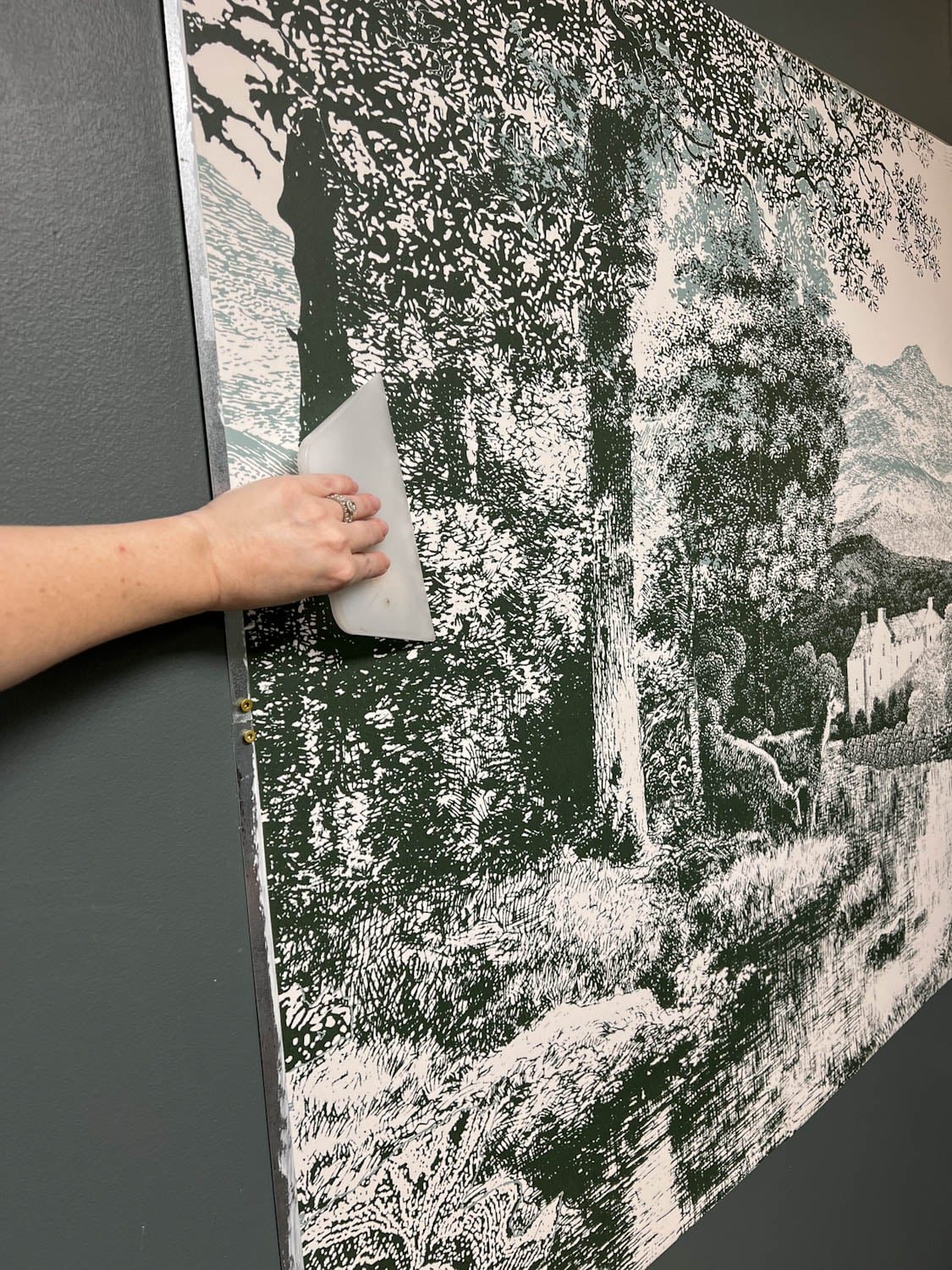 smoothing wall mural panels onto sheet metal