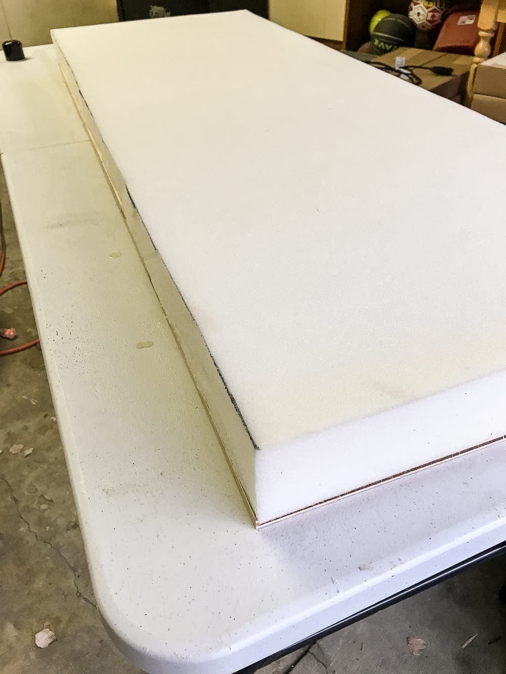 DIY Ottoman Bench from a Repurposed Thrift Store Coffee Table | unigumushane.com - How to repurpose an old coffee table into a designer-inspired ottoman bench with tips for getting a faux weathered wood look and how to tuft upholstery #furnituremakeover #ottoman #coffeetable