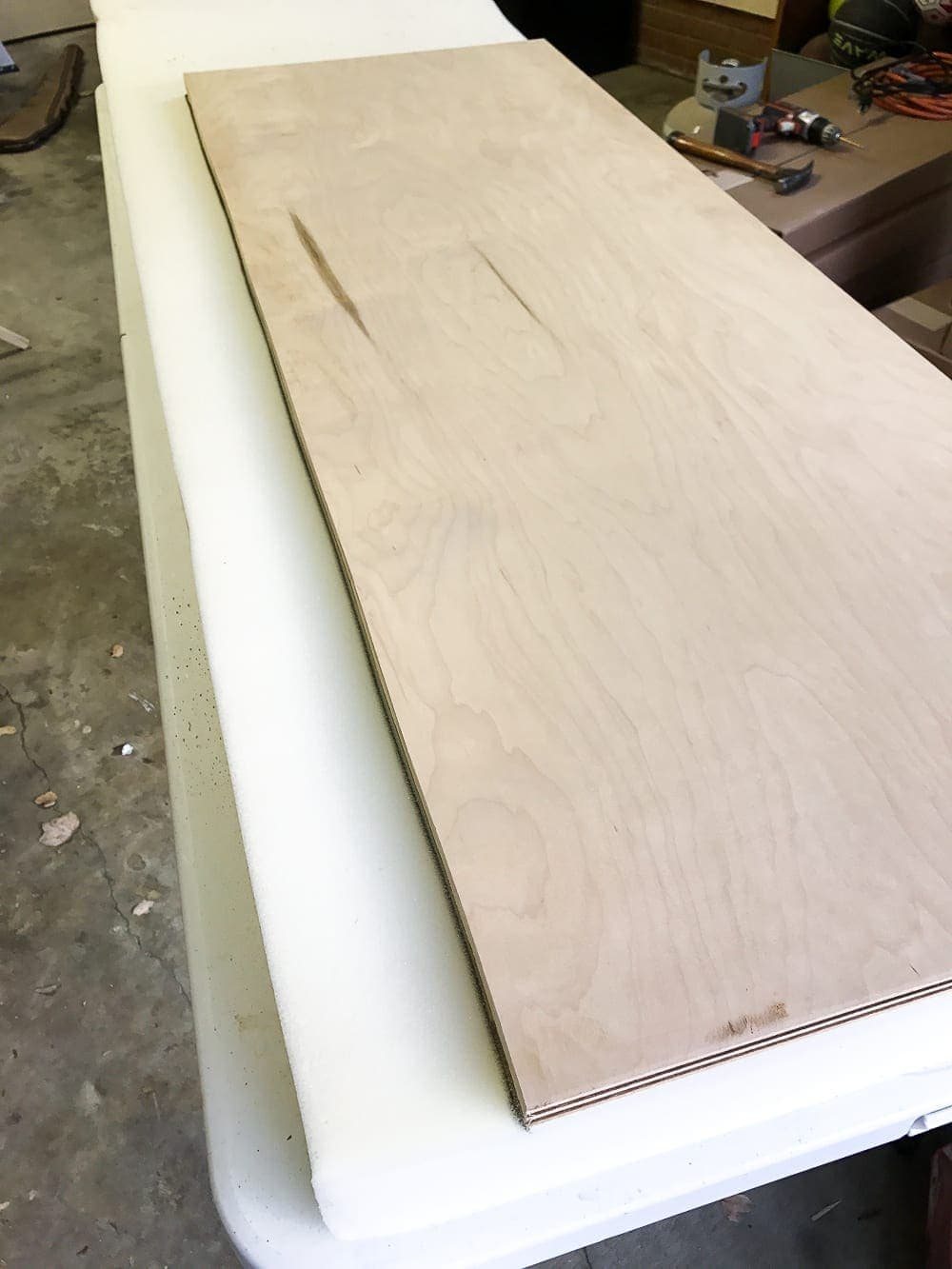 DIY Ottoman Bench from a Repurposed Thrift Store Coffee Table | unigumushane.com - How to repurpose an old coffee table into a designer-inspired ottoman bench with tips for getting a faux weathered wood look and how to tuft upholstery #furnituremakeover #ottoman #coffeetable