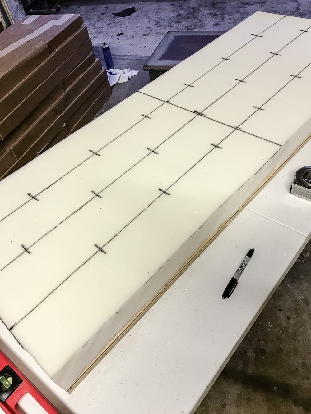 DIY Ottoman Bench from a Repurposed Thrift Store Coffee Table | unigumushane.com - How to repurpose an old coffee table into a designer-inspired ottoman bench with tips for getting a faux weathered wood look and how to tuft upholstery #furnituremakeover #ottoman #coffeetable