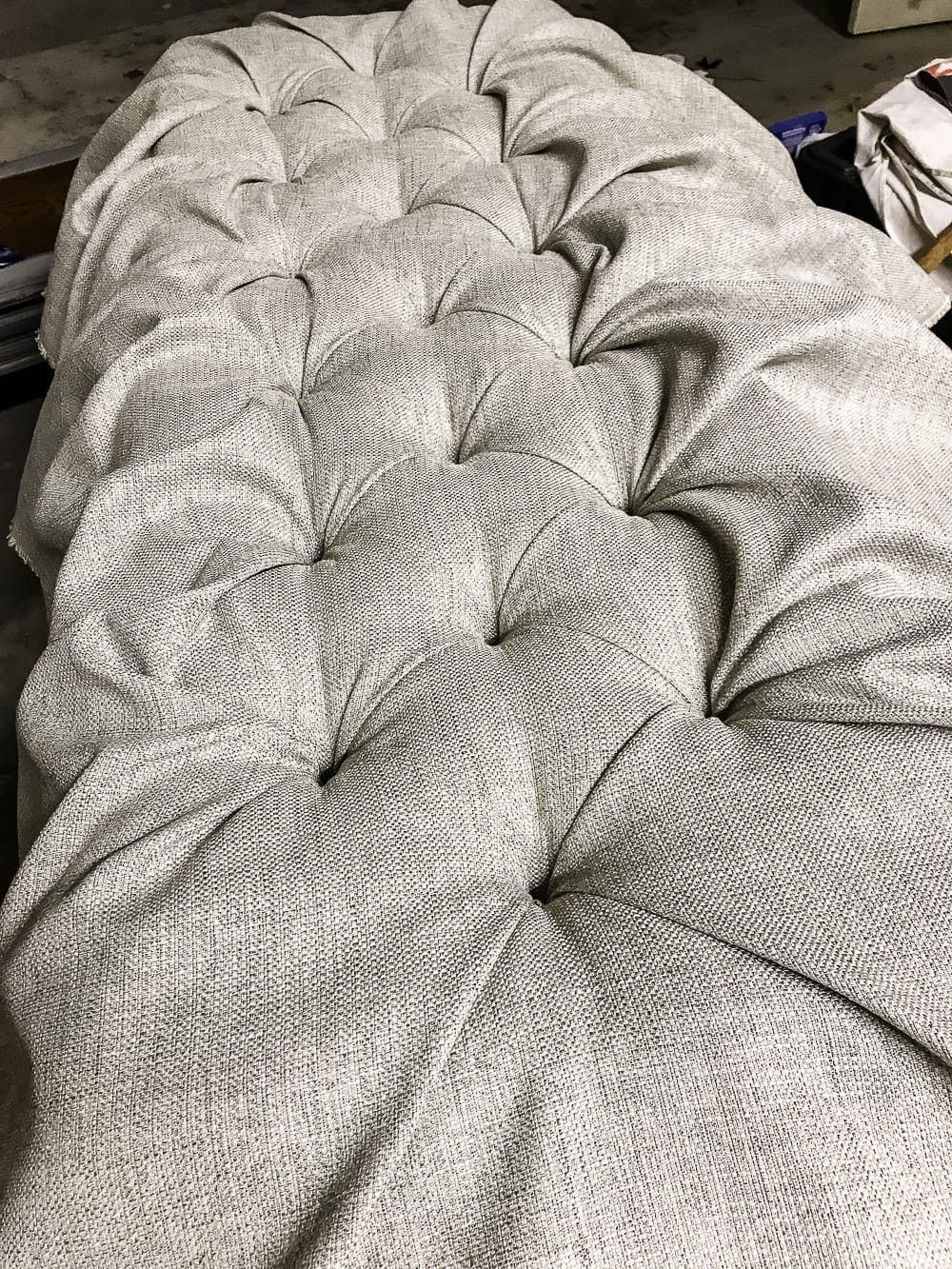 DIY Ottoman Bench from a Repurposed Thrift Store Coffee Table | unigumushane.com - How to repurpose an old coffee table into a designer-inspired ottoman bench with tips for getting a faux weathered wood look and how to tuft upholstery #furnituremakeover #ottoman #coffeetable