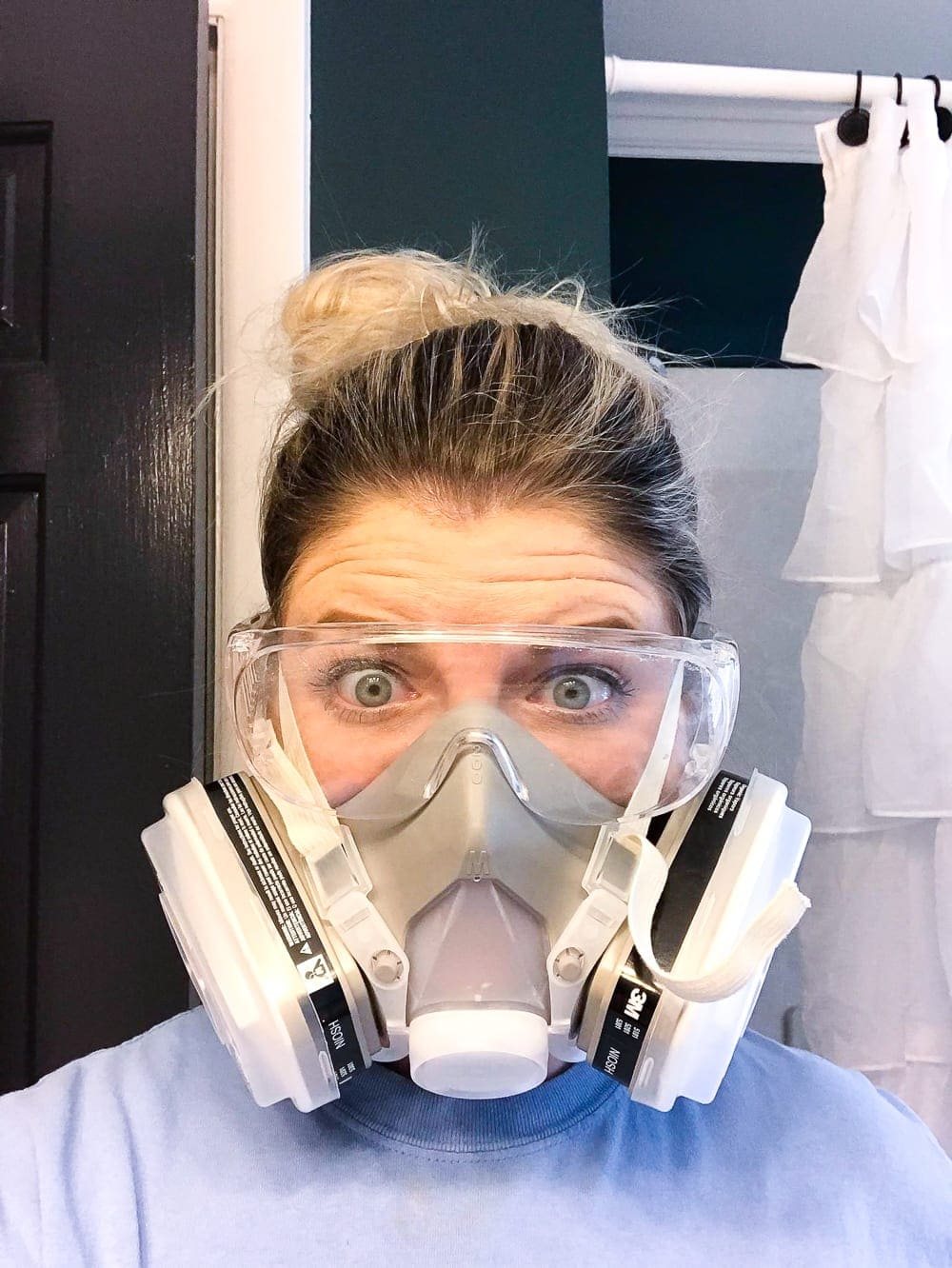 wearing a respirator mask to paint a countertop