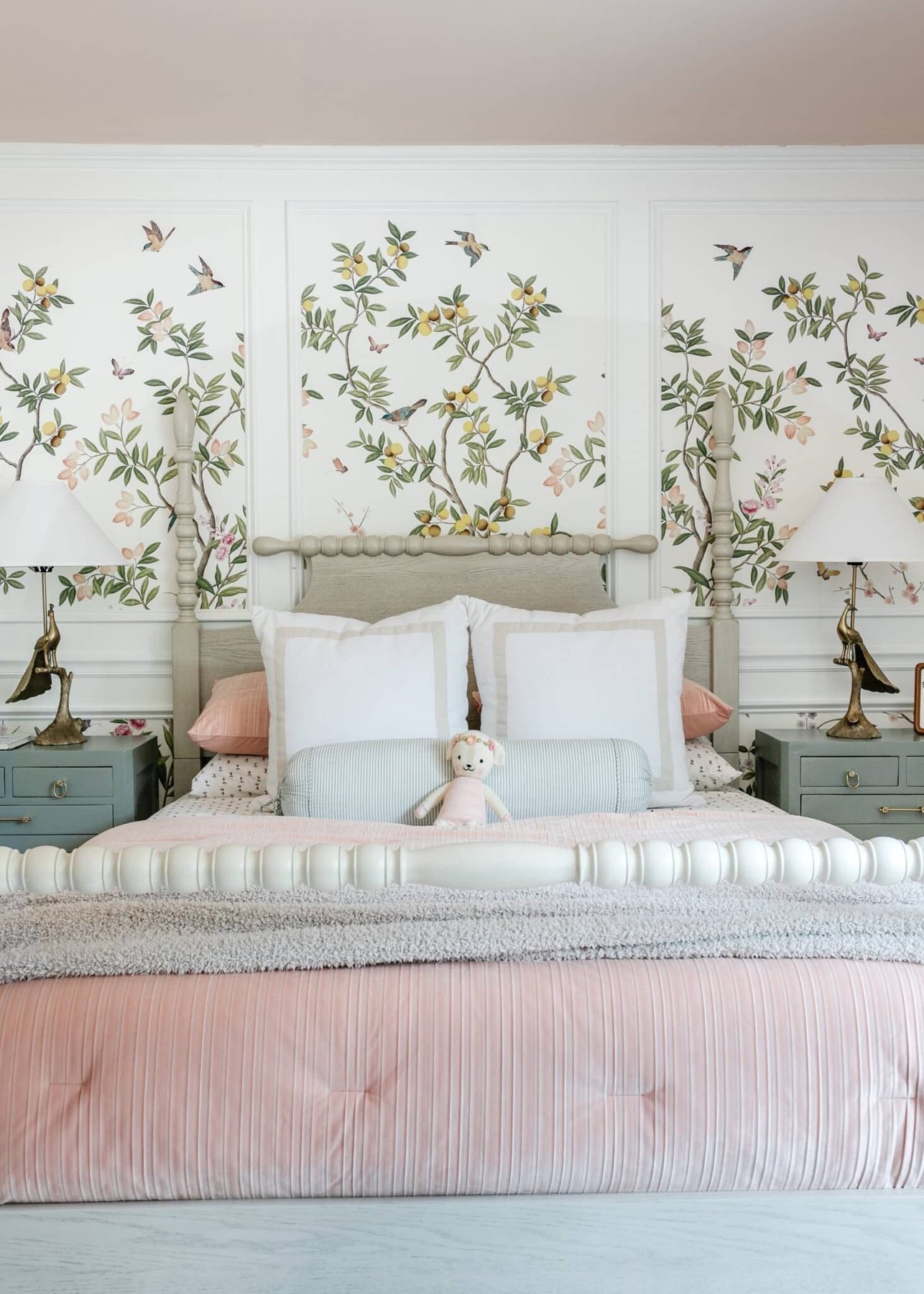 beige poster bed with chinoiserie wallpaper and pink bedding