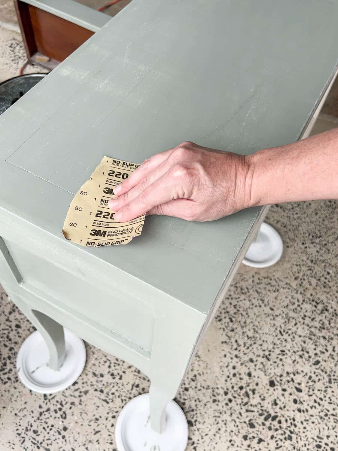 sanding a nightstand for a smooth painted finish