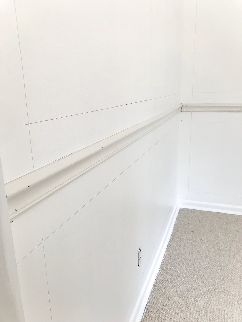 mark walls for picture frame molding using a 4" board as a spacer
