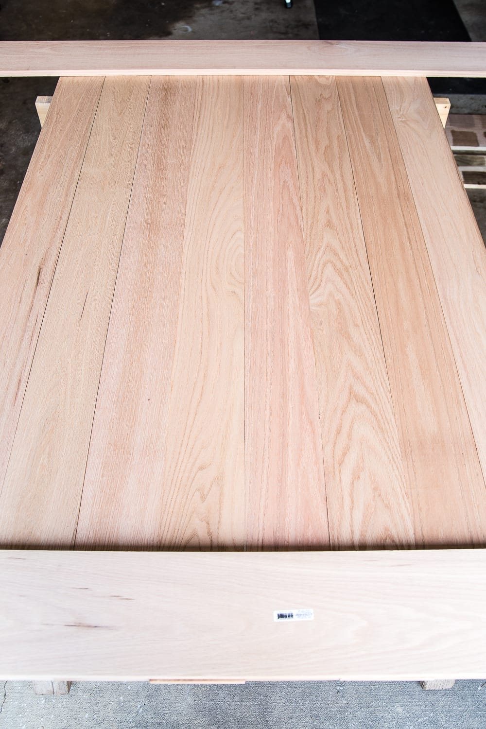 A tutorial for how to build a retrofitted table top to fit over any existing table using Minwax Dark Walnut stain. #build #furniturebuilding #tabletop #diningtable #diytable #farmhousetable #diyfurniture #woodworking #furnituremakeover #tablemakeover #minwax #woodstain #walnut