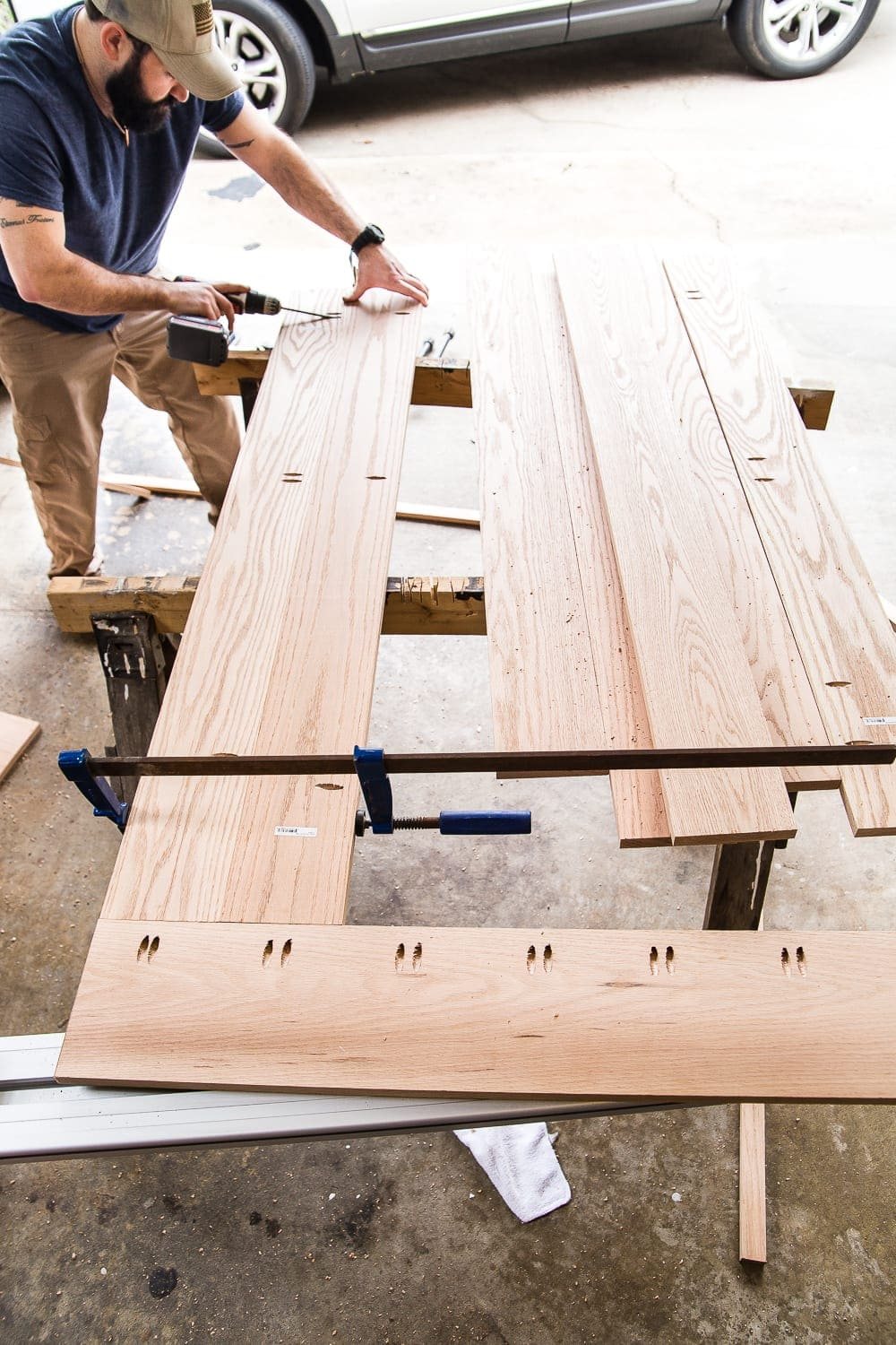 A tutorial for how to build a retrofitted table top to fit over any existing table using Minwax Dark Walnut stain. #build #furniturebuilding #tabletop #diningtable #diytable #farmhousetable #diyfurniture #woodworking #furnituremakeover #tablemakeover #minwax #woodstain #walnut