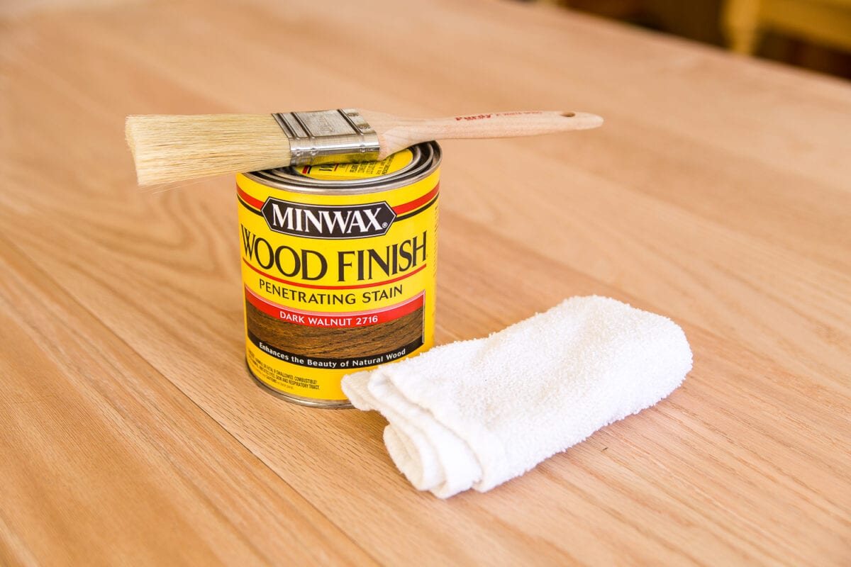 A tutorial for how to build a retrofitted table top to fit over any existing table using Minwax Dark Walnut stain. #build #furniturebuilding #tabletop #diningtable #diytable #farmhousetable #diyfurniture #woodworking #furnituremakeover #tablemakeover #minwax #woodstain #walnut