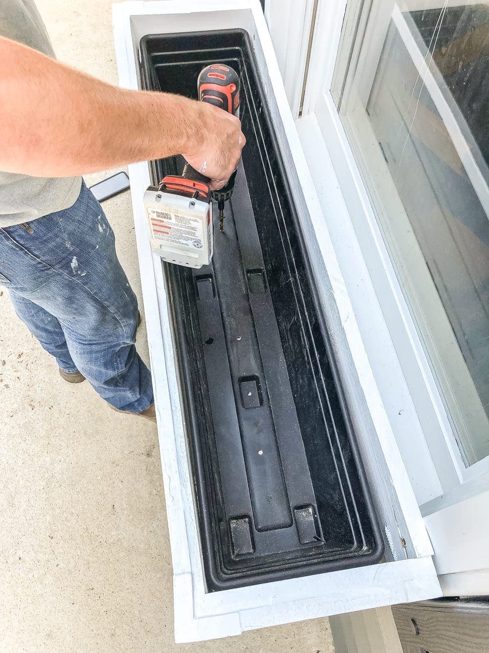 DIY window box with holes drilled in bottom for drainage