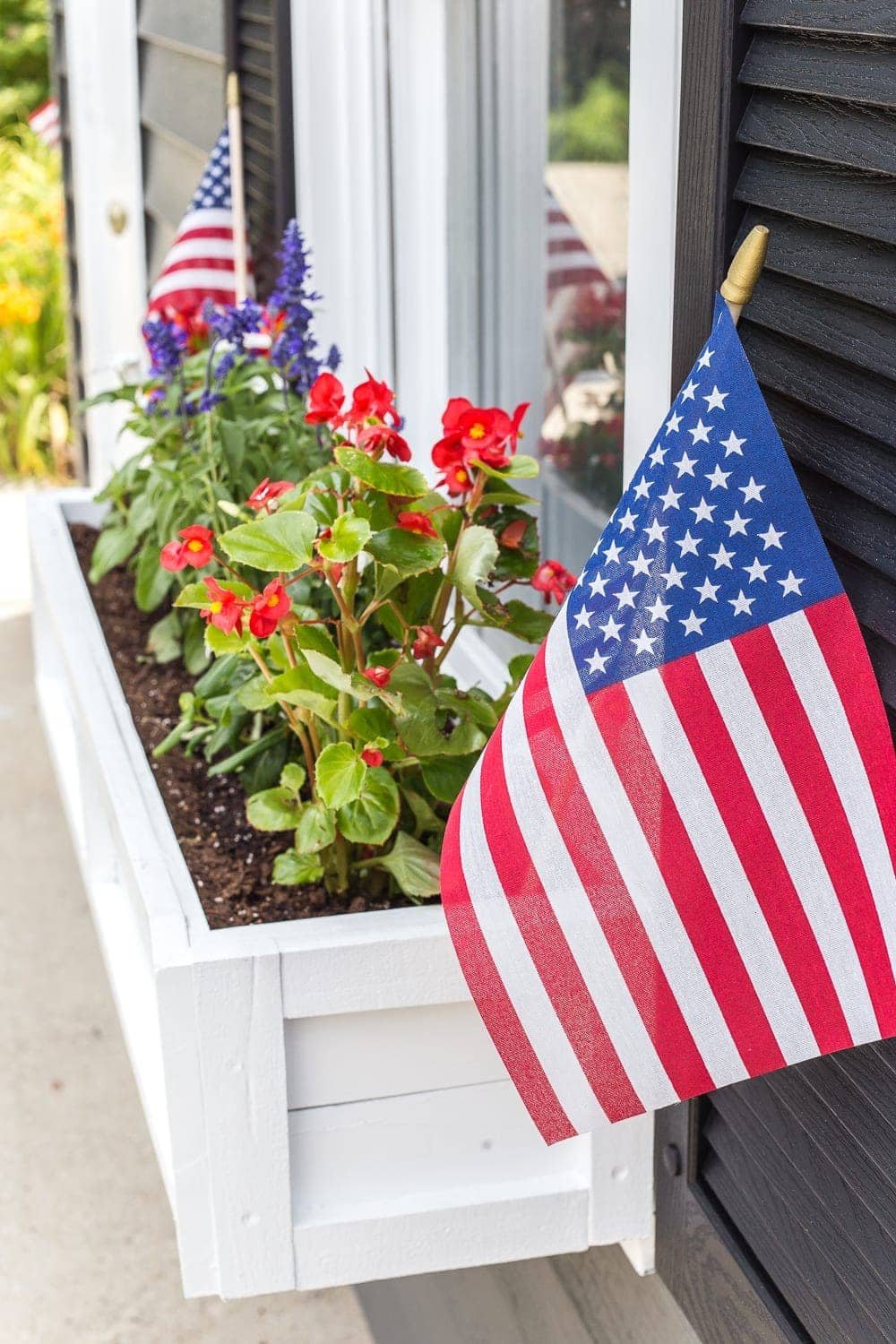 DIY window box using scrap wood with red, white, and blue patriotic flowers for July 4th