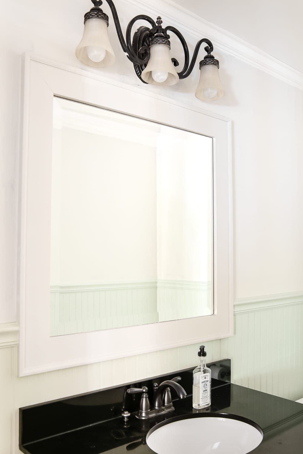 Dry Brushed Black Mirror Makeover | unigumushane.com - A plain, white painted bathroom mirror gets a high-drama weathered makeover with black paint and dry brushing. (Tutorial)