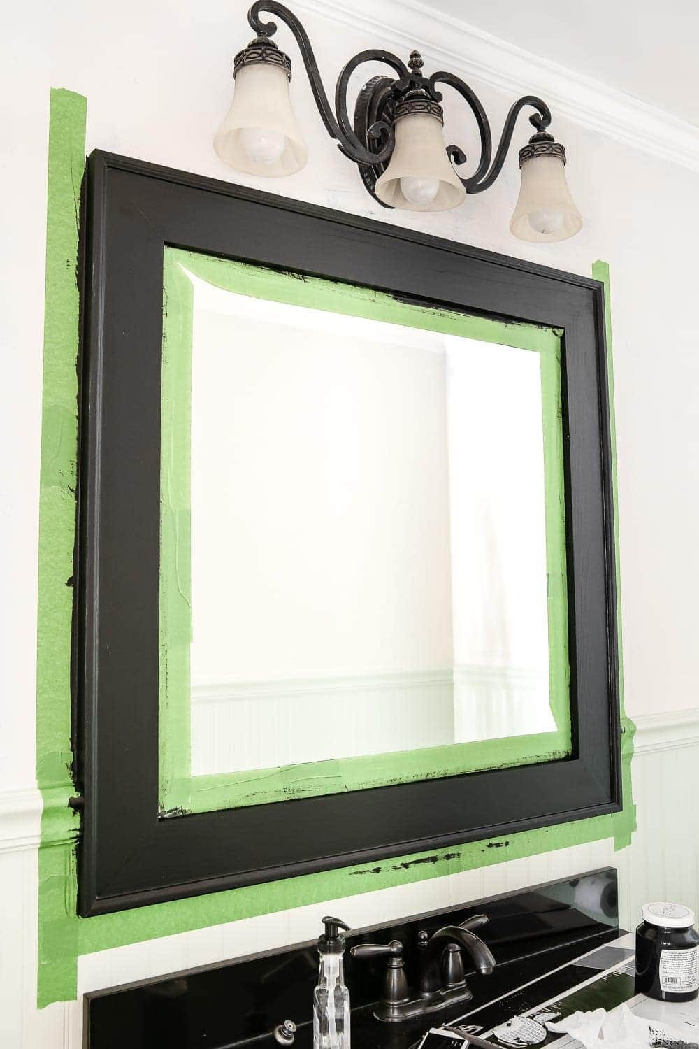Dry Brushed Black Mirror Makeover | unigumushane.com - A plain, white painted bathroom mirror gets a high-drama weathered makeover with black paint and dry brushing. (Tutorial)