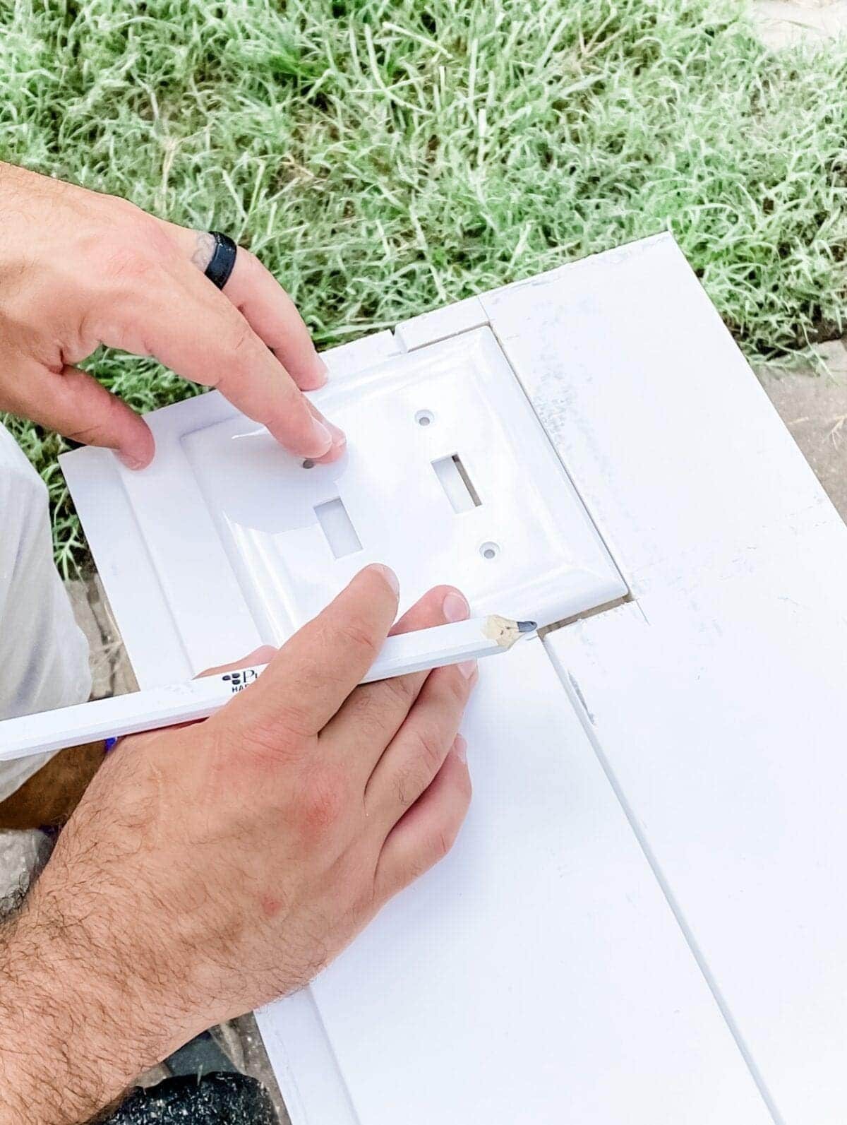 tracing an outlet cover on shiplap boards