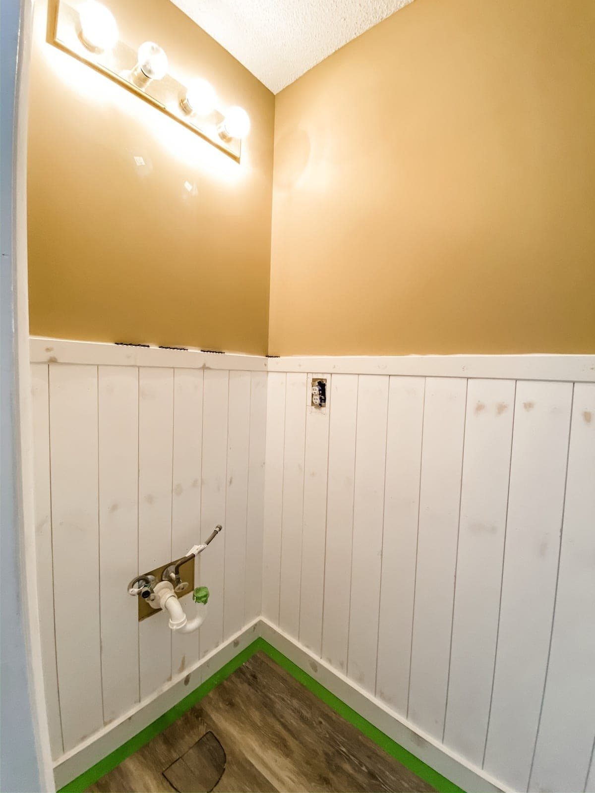 vertical shiplap wainscoting in a bathroom before painting