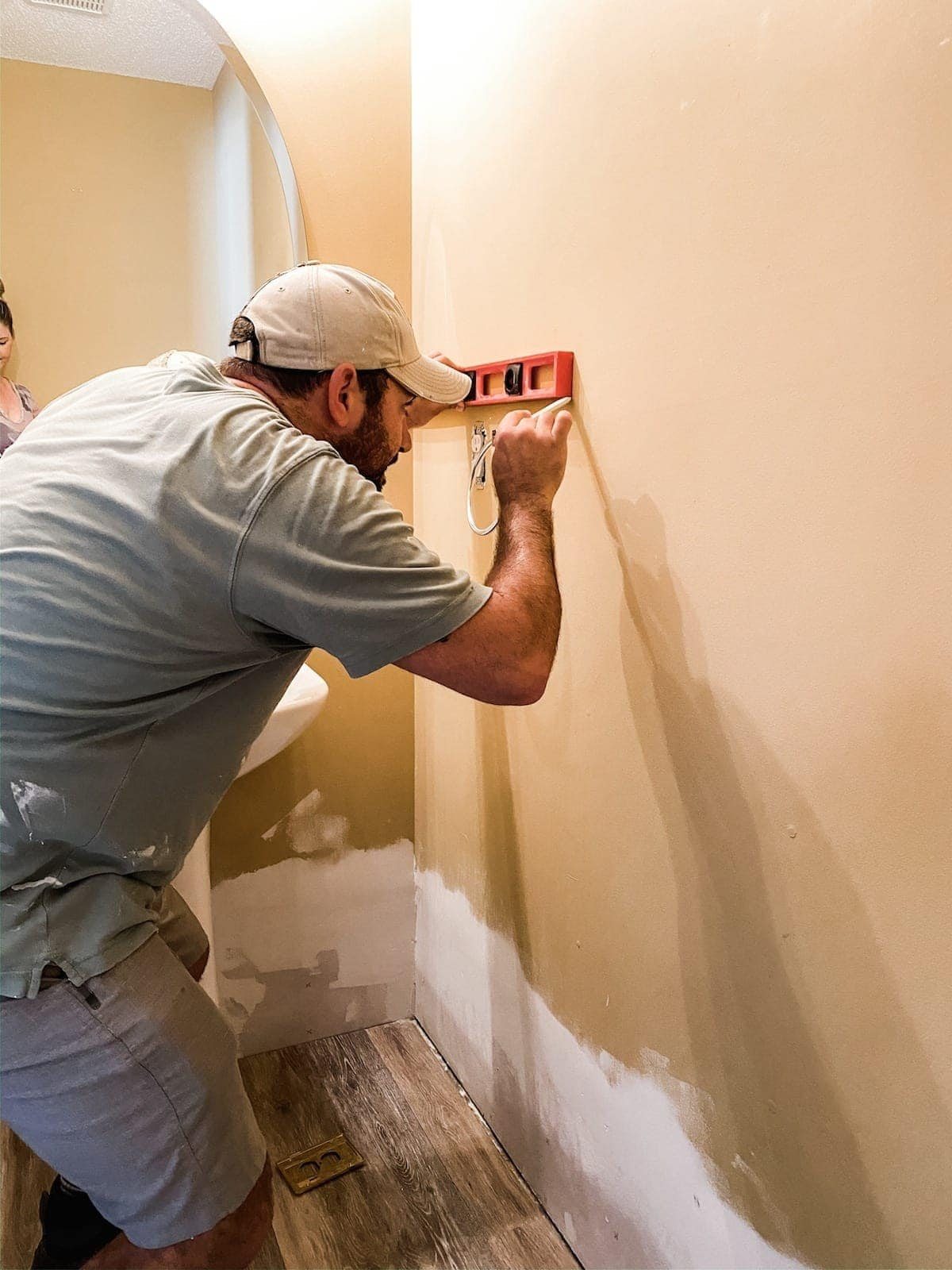 marking a wall with a level for shiplap placement