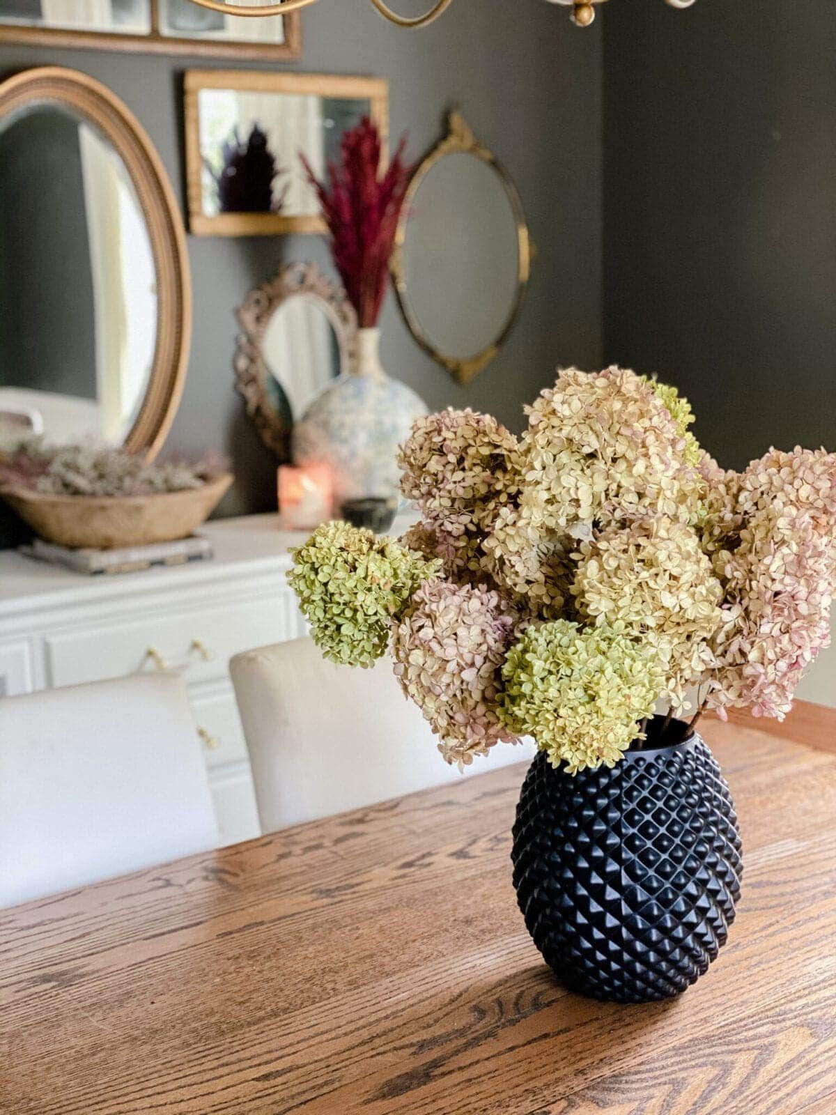 dried hydrangeas used as DIY fall decor to create a cozy home in a dining room