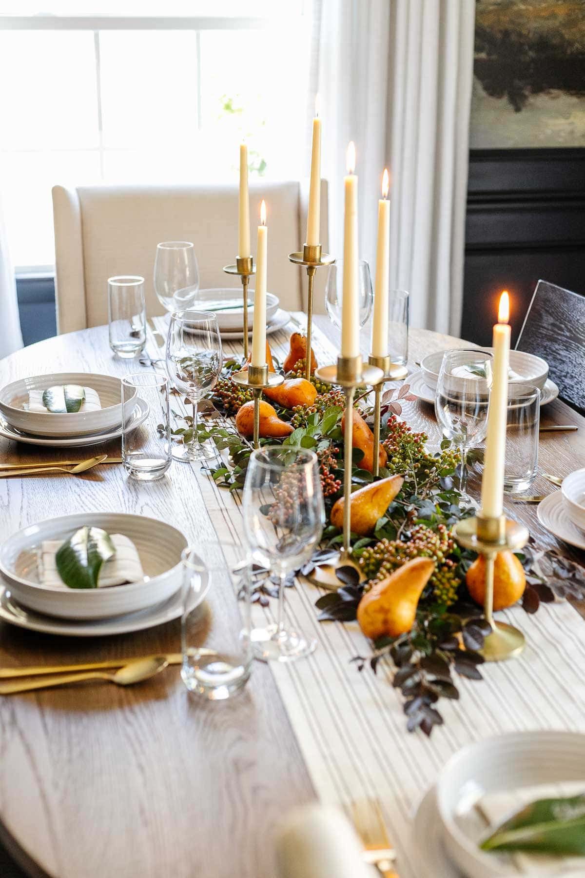 simple Thanksgiving centerpiece idea : candles, stems from the backyard, and pears