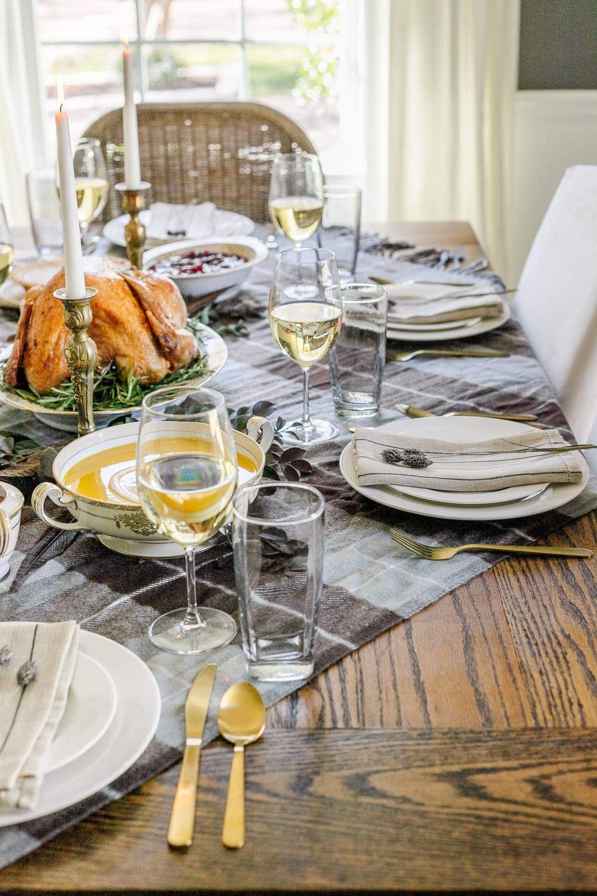 plaid throw blanket used on a dining table as a tablecloth to set the mood of a cozy home