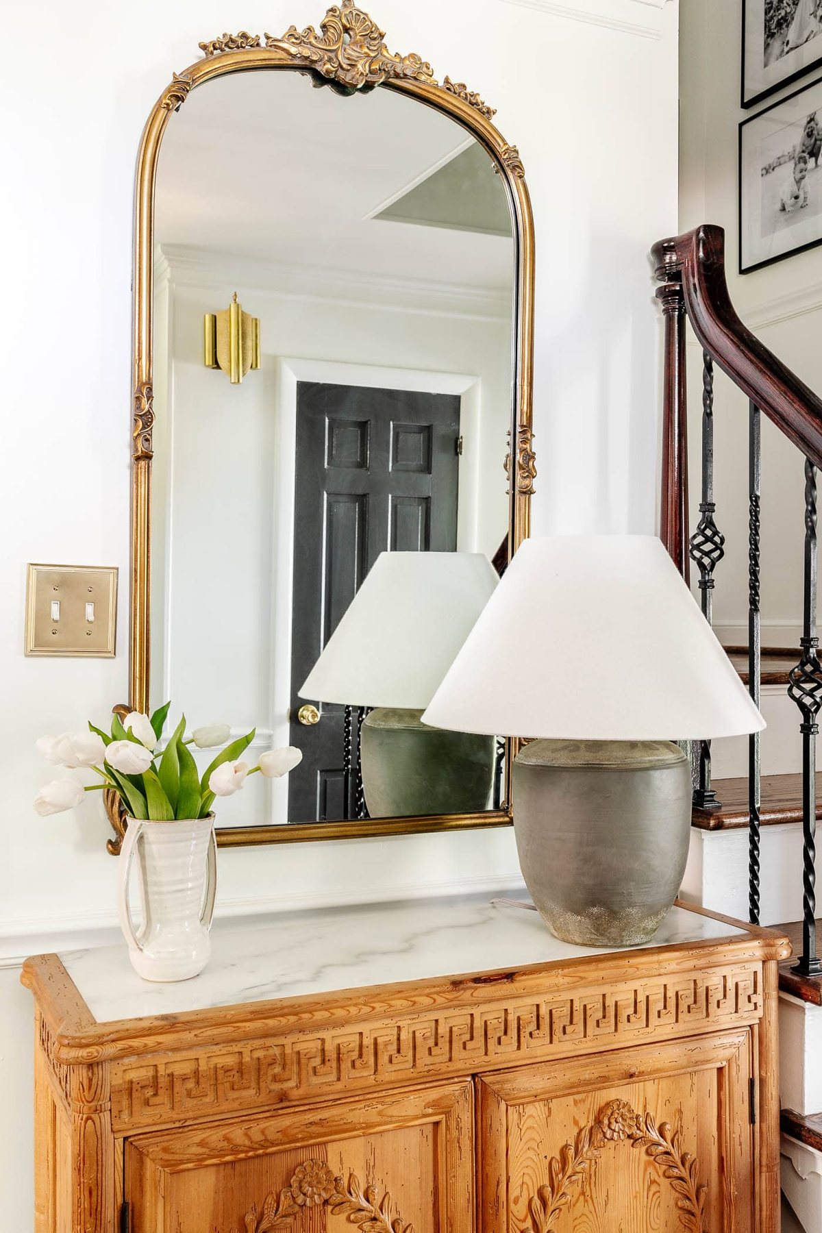 flanking a table lamp with a vase of flowers