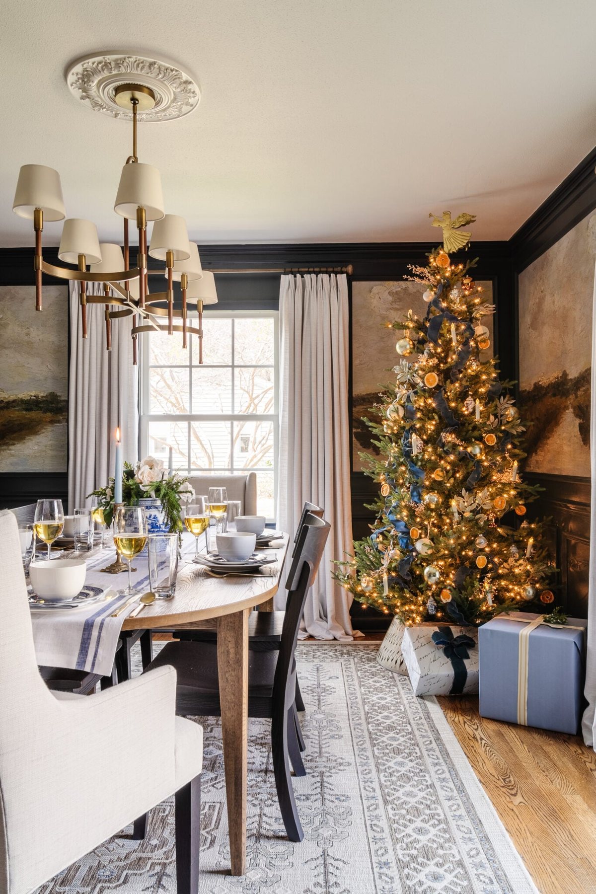 dining room set for Christmas with glowing tree in corner