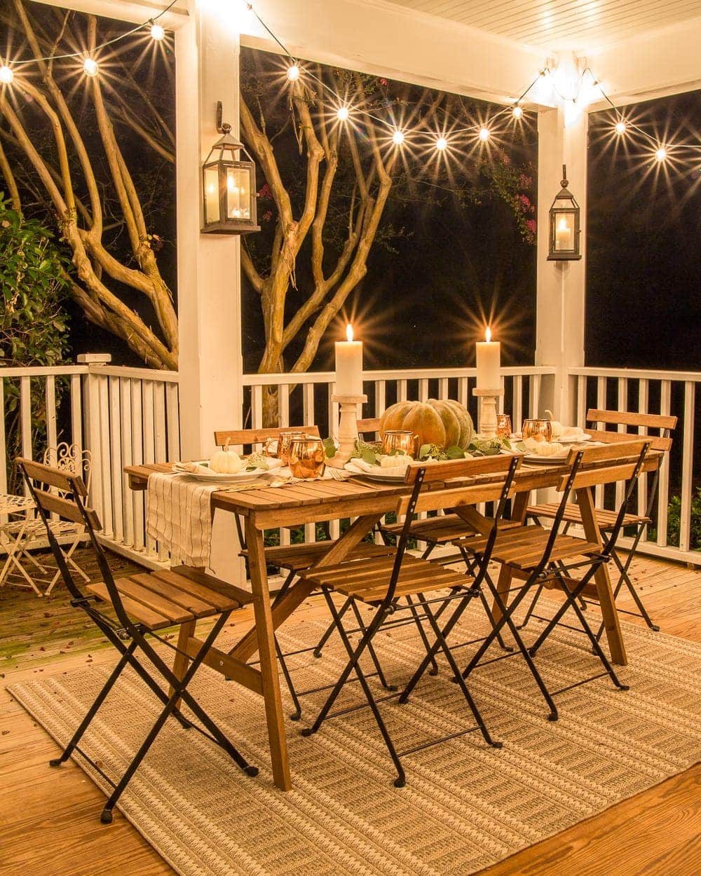 Fall Back Porch at Night | How to style your outdoor spaces for autumn using capsule decor items that will last throughout the seasons and get the most bang for your buck.