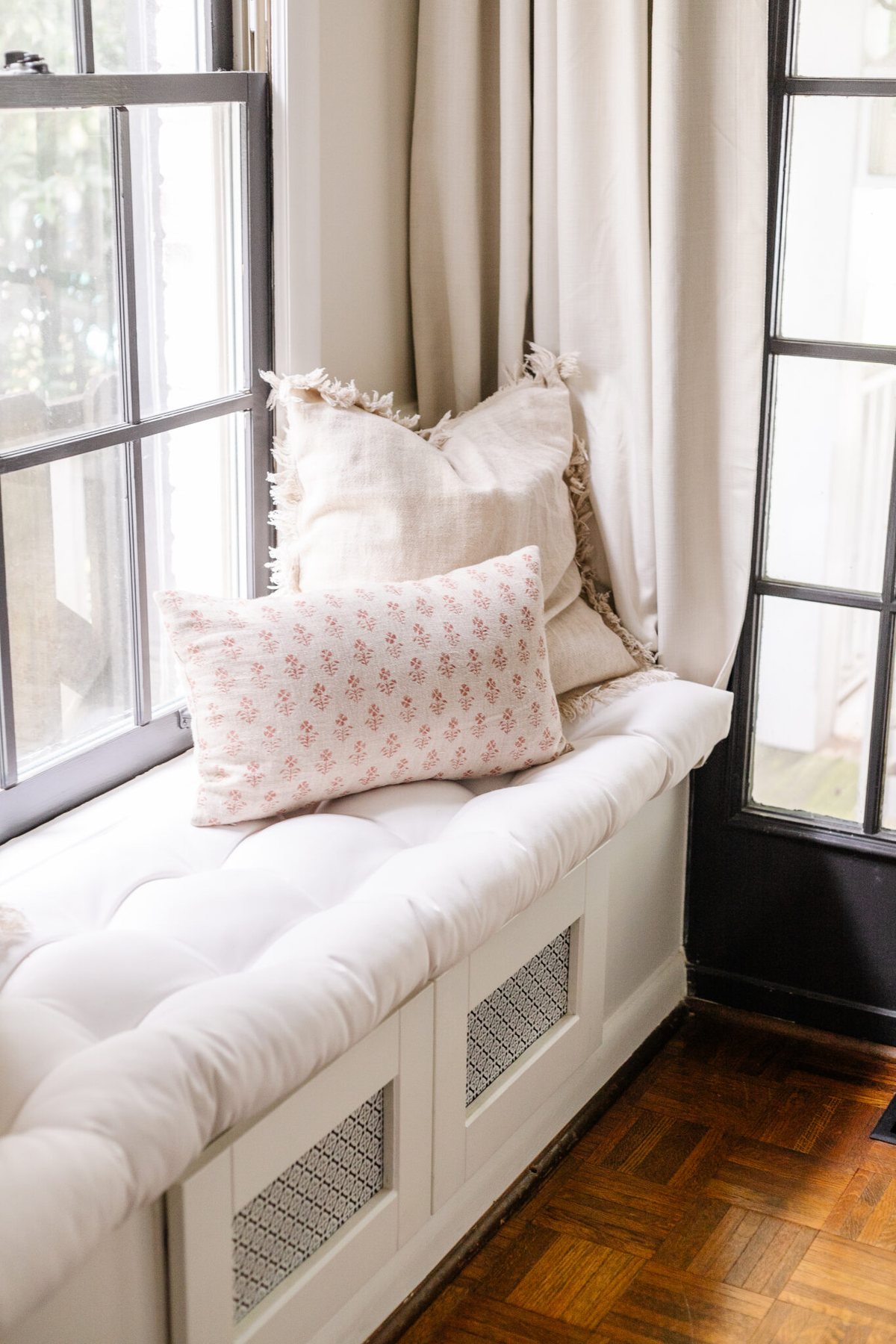 window seat in a living room with neutral fall pillows