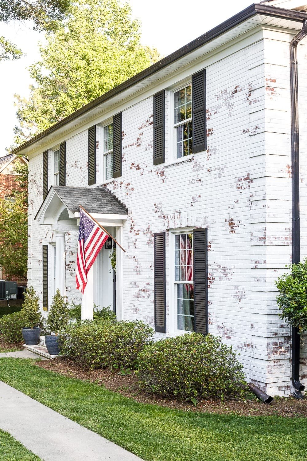 FAQs About Our Limewashed Brick | All of our frequently asked questions about our limewashed brick concerning neighbors' opinions, trends, DIY-ability, and why we chose it over paint. #limewash #brickexterior #limewashedbrick #brickpaint #paintedbrick #exteriormakeover #curbappeal #brickhouse