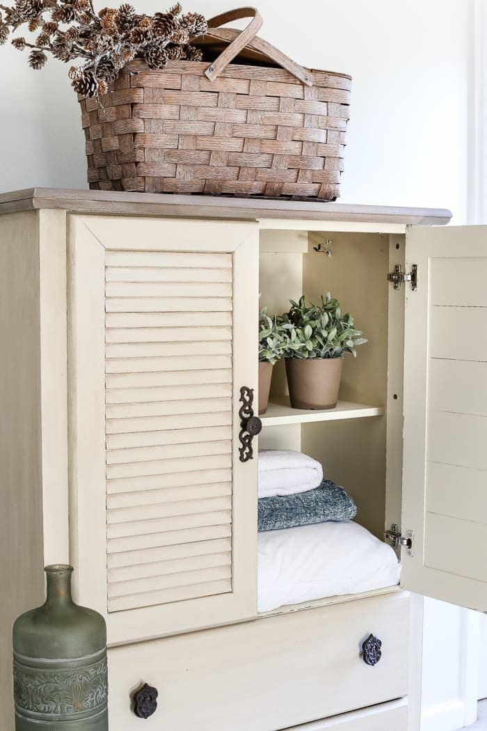 Faux Antique Shutter Armoire Makeover | unigumushane.com - A basic veneer cabinet gets a faux antique makeover using Fusion Mineral Paint in the color Plaster aged with Espresso wax and cast iron hardware.