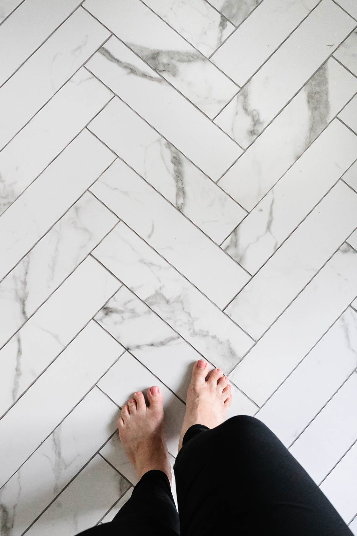 faux marble herringbone tile floor with gray grout