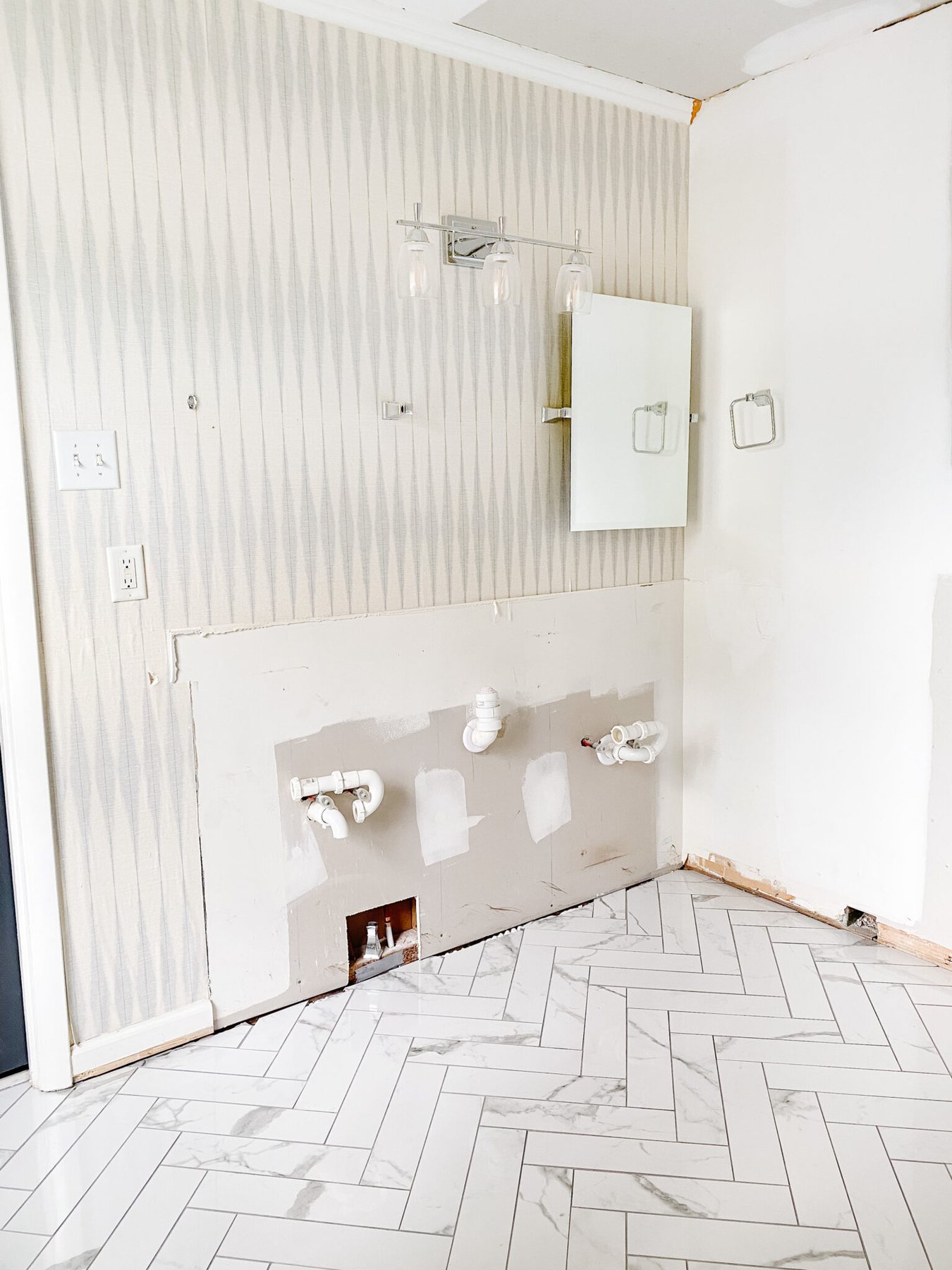 faux marble herringbone tile floor in a bathroom renovation