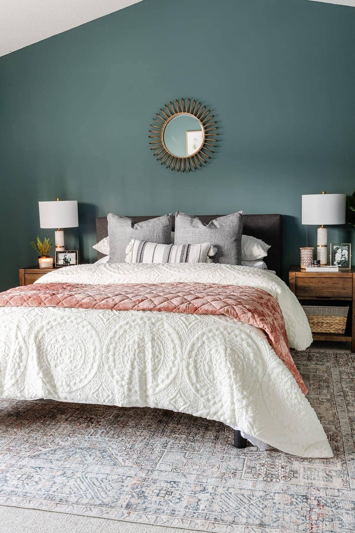 bedroom decorated with teal walls and loloi rug from Chris Loves Julia