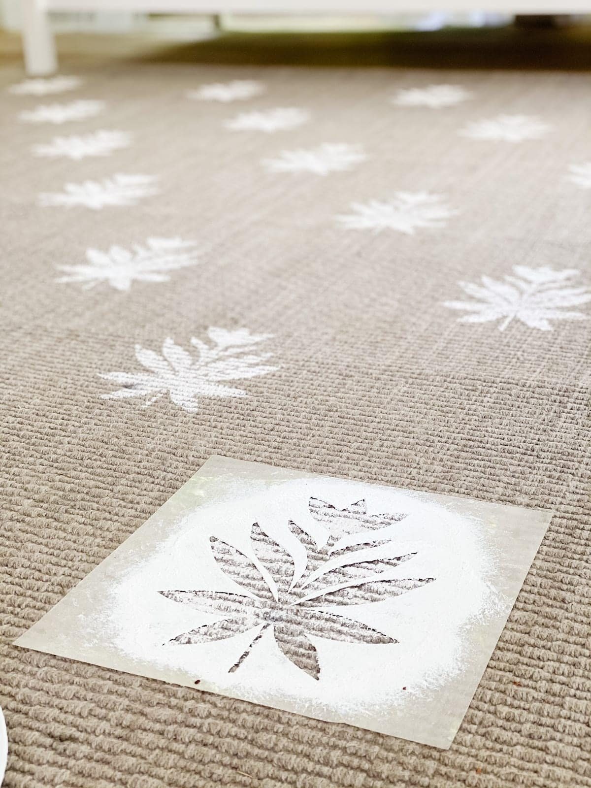 DIY outdoor rug with floral block pattern using a homemade stencil from a Cricut machine