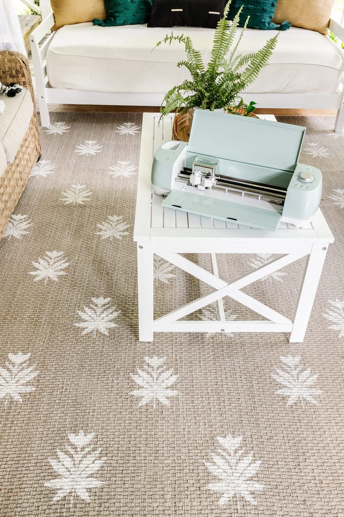 DIY outdoor rug with a floral block pattern using a stencil made from a Cricut machine