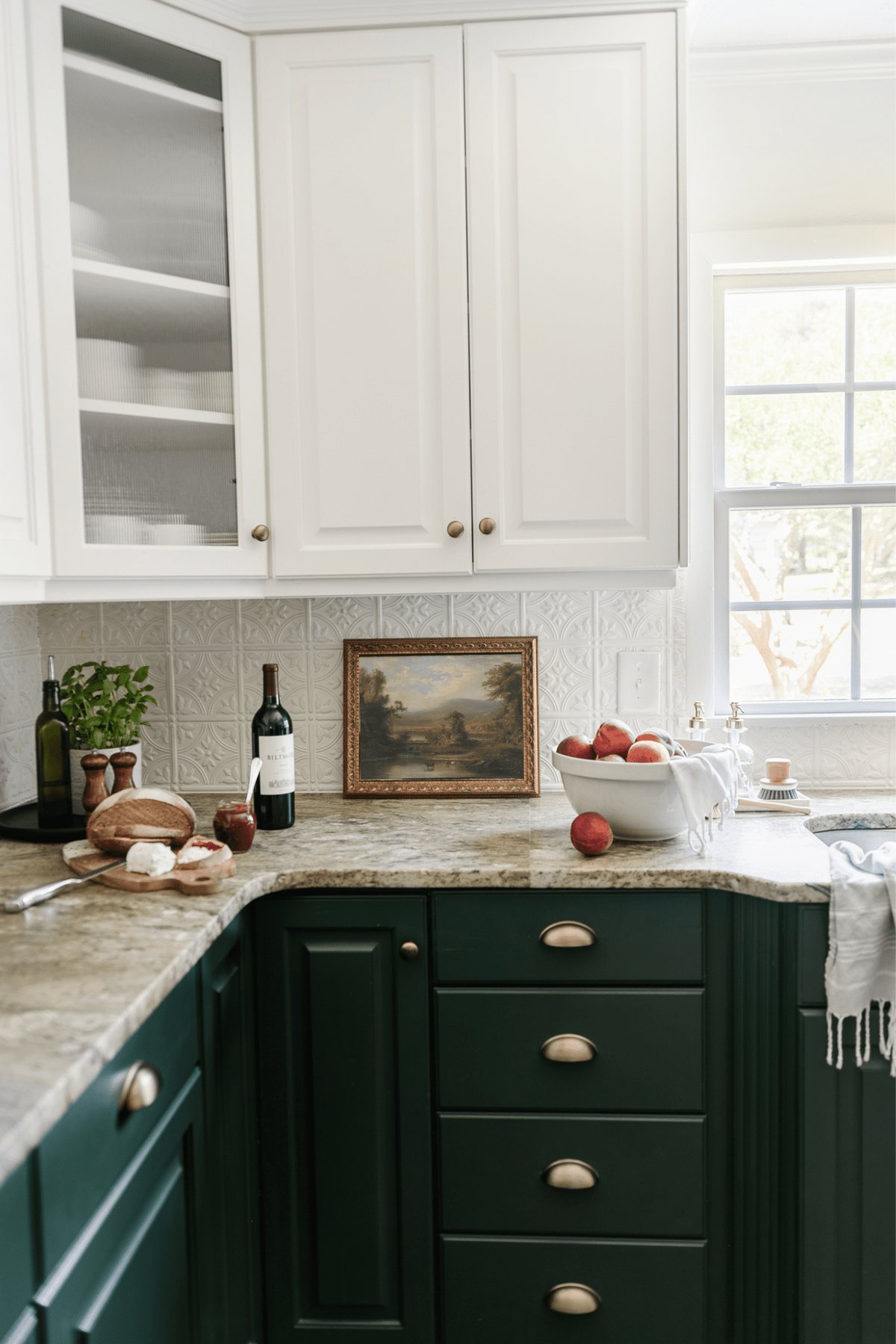 framed landscape oil painting print as kitchen art on a countertop