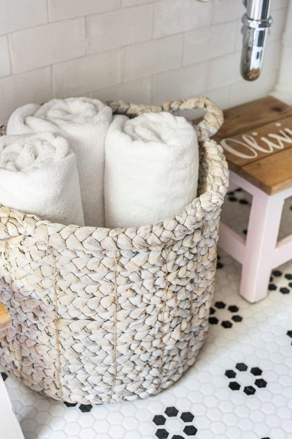 Girls' Bathroom Decor Details & Sources | basket of towels underneath an open vanity table