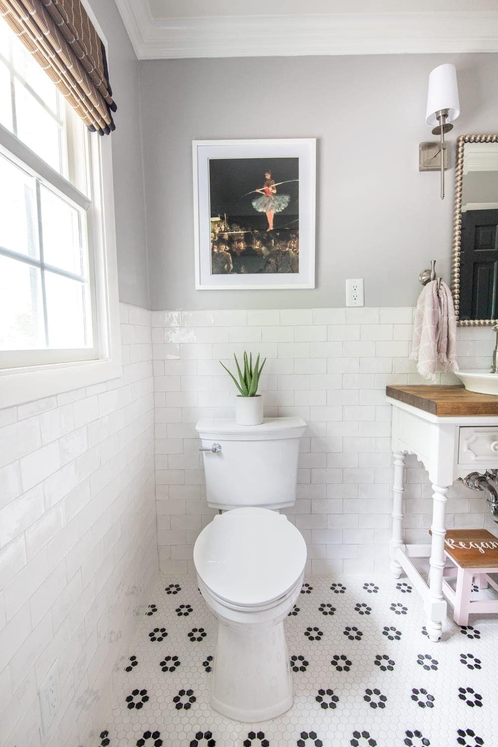 Girls' Bathroom Decor Details & Sources | Self cleaning toilet, retro flower floor tile, handmade subway wall tile, and vintage tightrope walker art