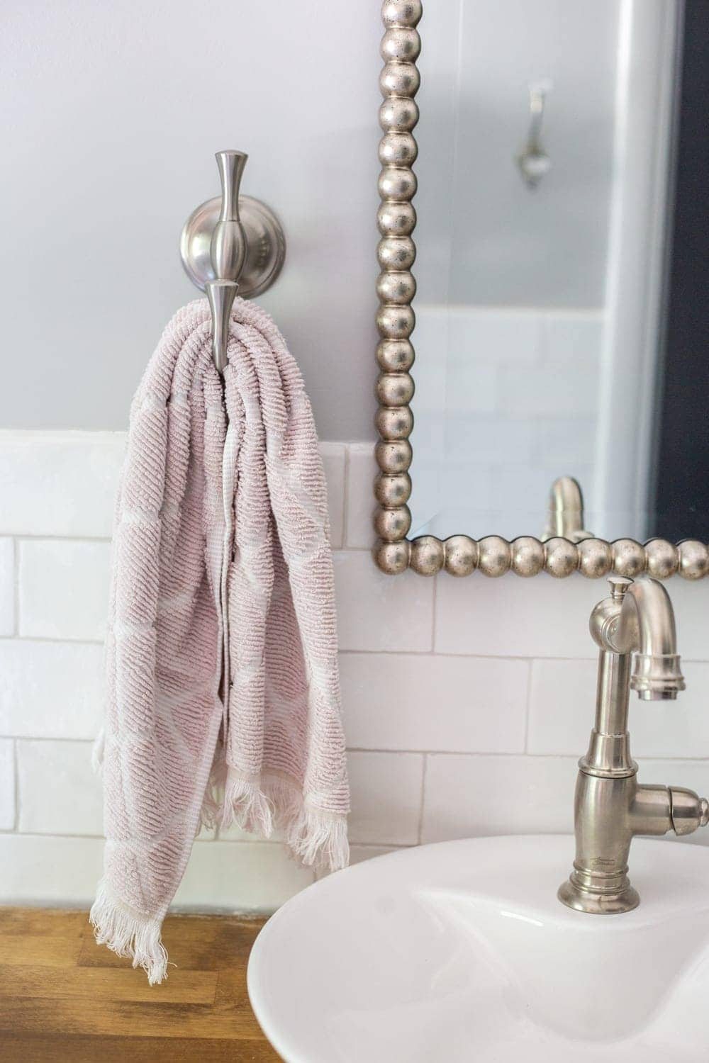 Girls' Bathroom Decor Details & Sources | hand towel hook, beaded mirror, vessel sink on butcher block countertop