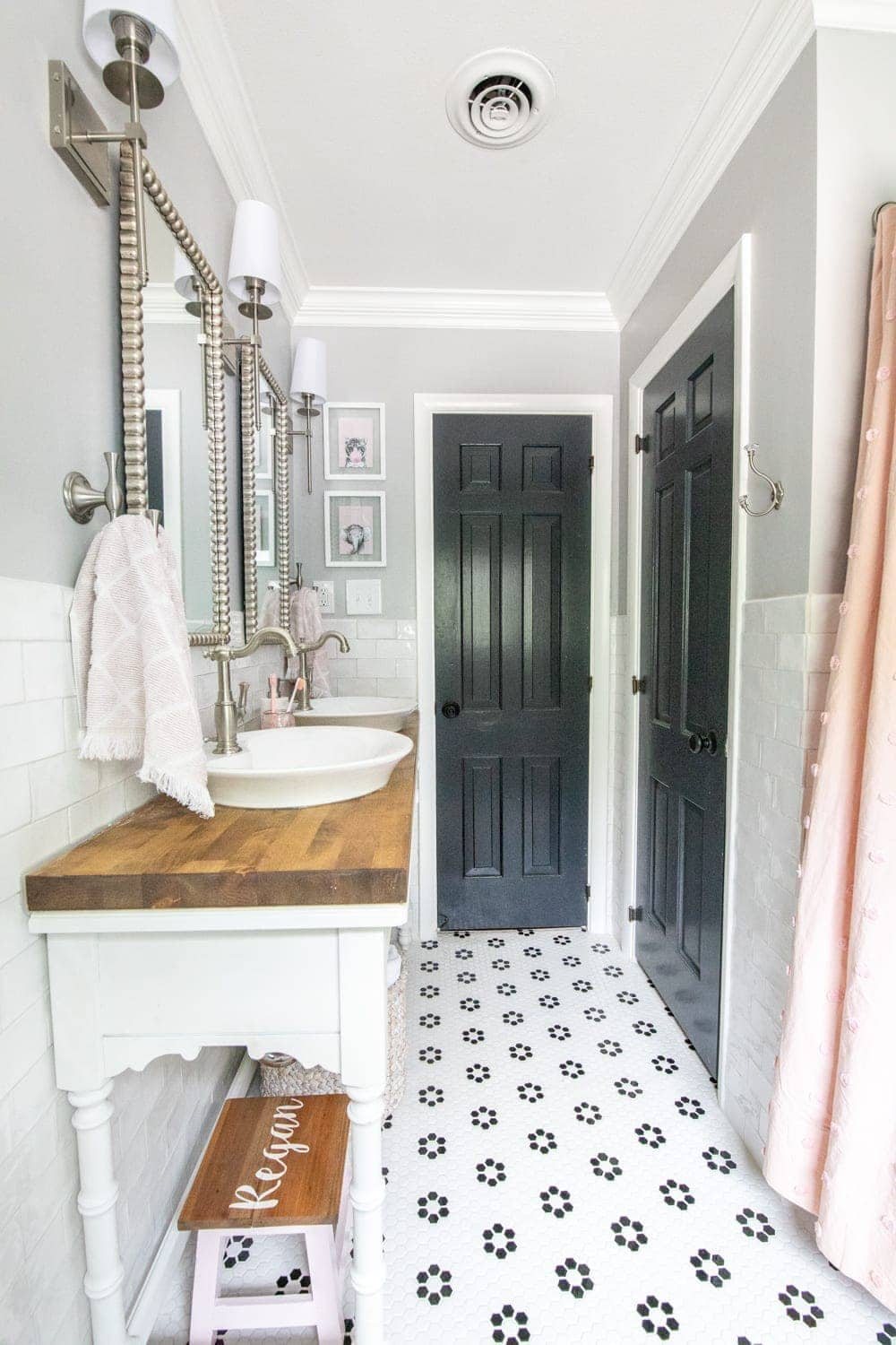 Whimsical, classic kids bathroom makeover | open vanity table and retro flower floor tile