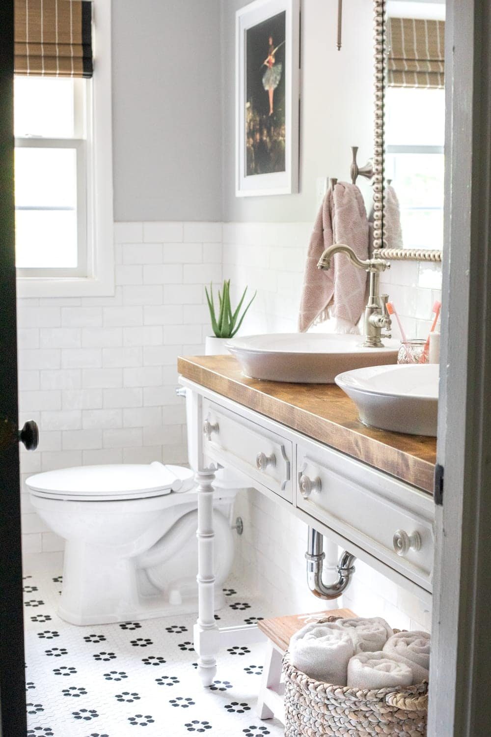 Girls' Bathroom Decor Details & Sources | Console table converted into a vanity with vessel sinks and retro flower floor tile