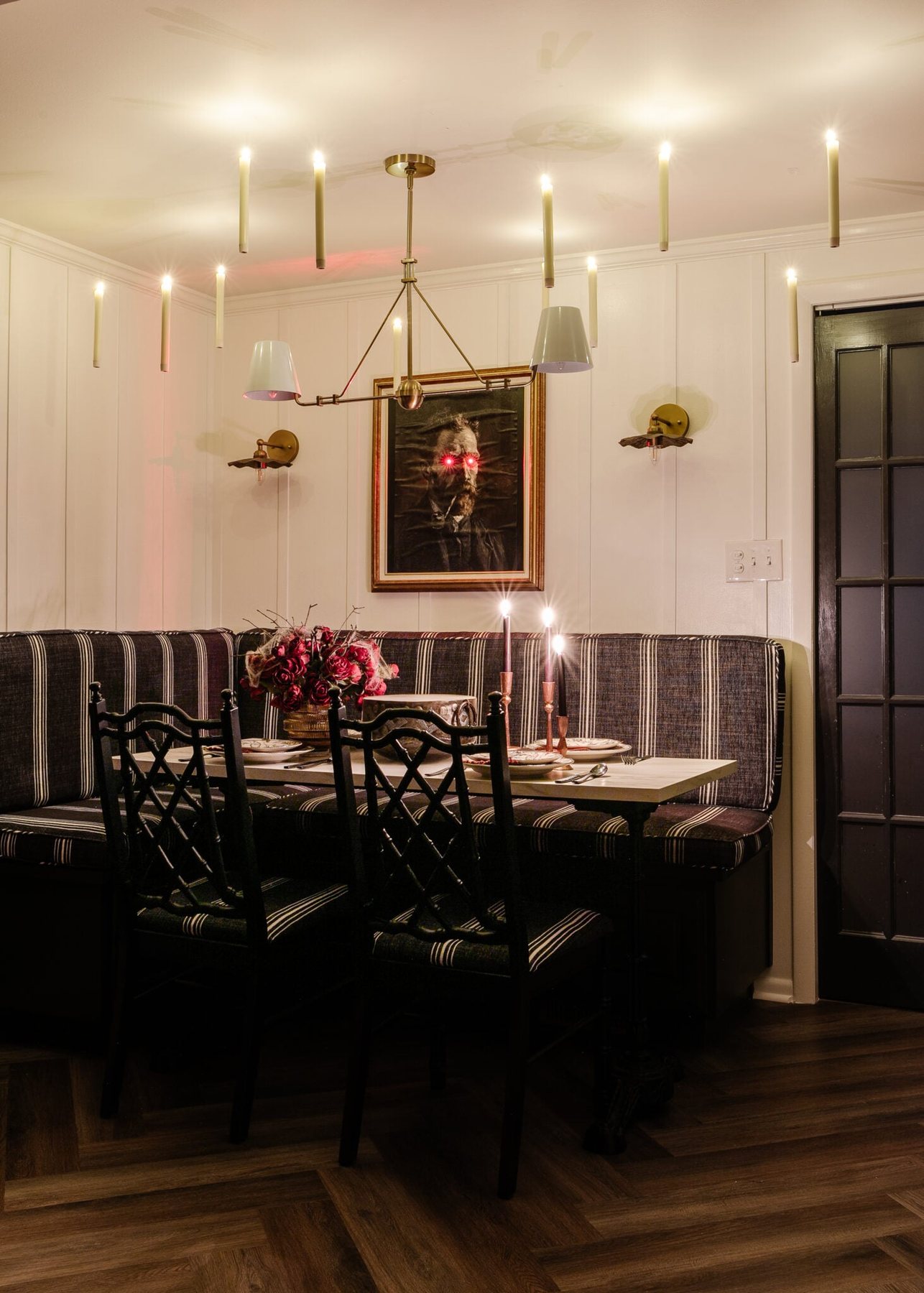 murder mystery dinner party with Halloween art portrait, floating candles, and dinnerware