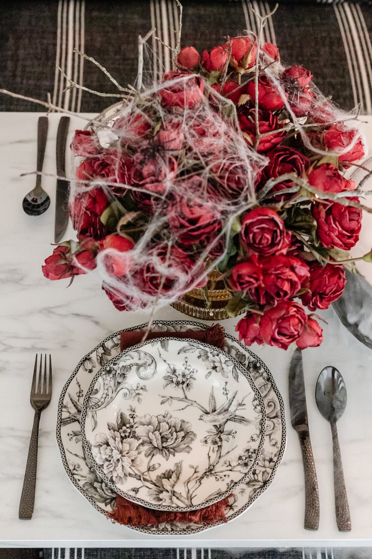 black toile plates and hammered black flatware Halloween place setting