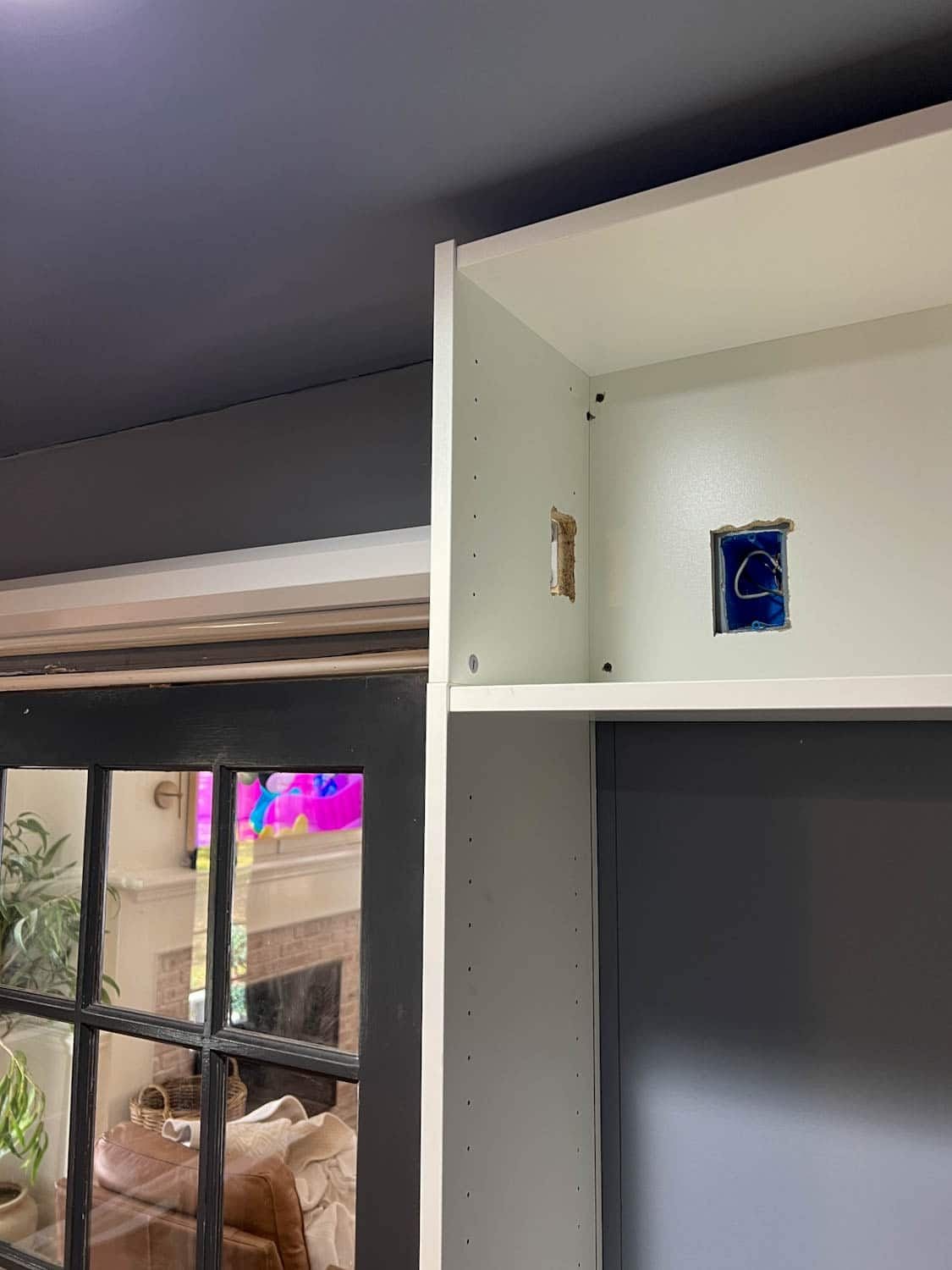 cutting a hole in bookcase for outlet access