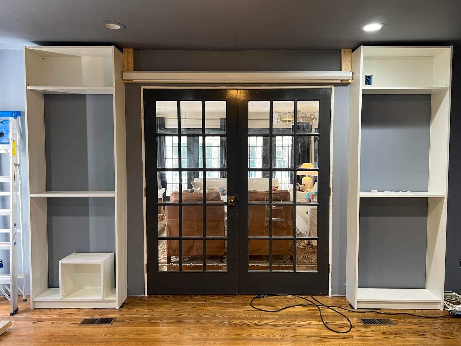 screen hung above French doors on 2x4s