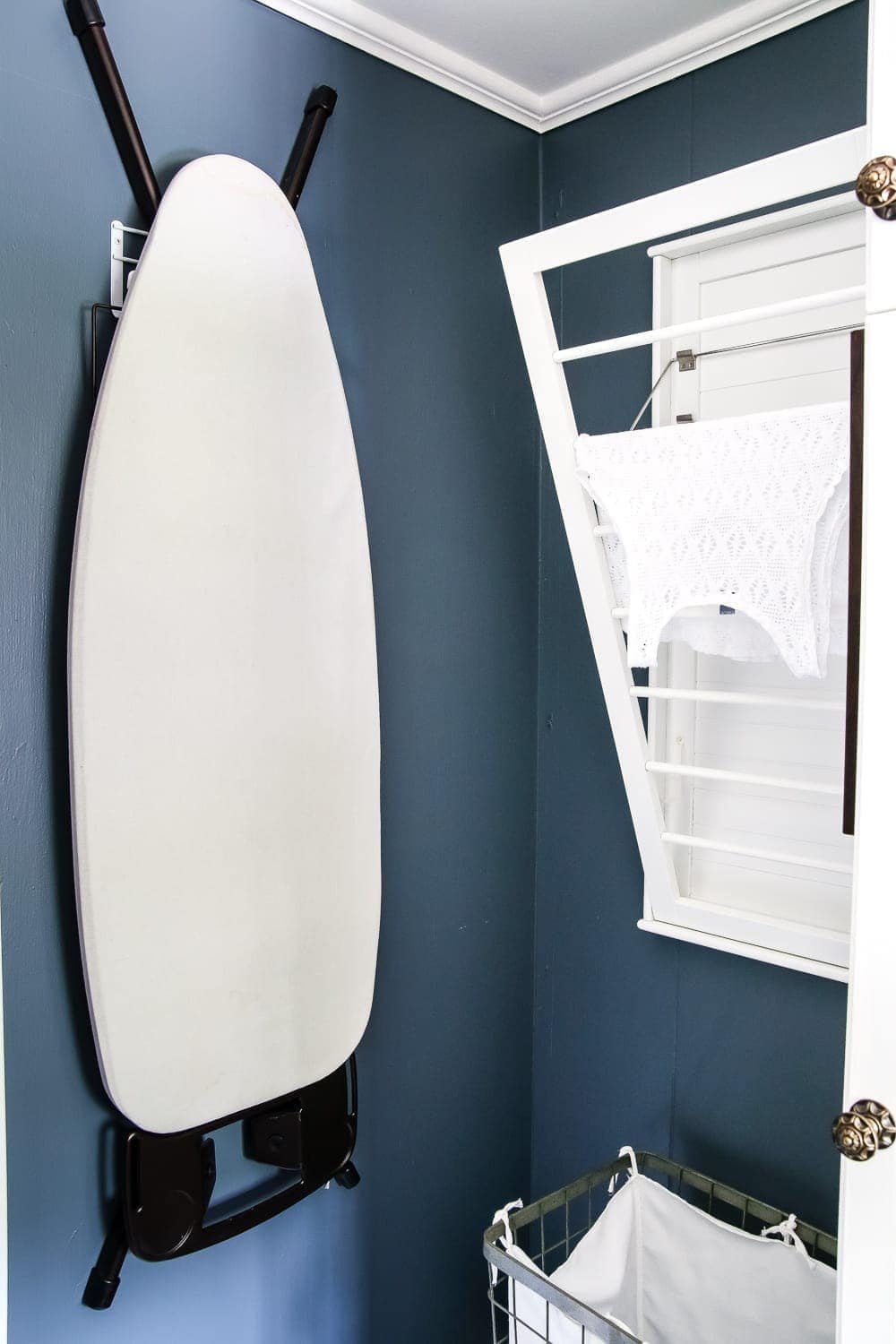 High Contrast Laundry Room Makeover | unigumushane.com - A dingy and dated laundry room gets a high contrast navy and white makeover packed with organizational strategies and budget-conscious DIY projects.
