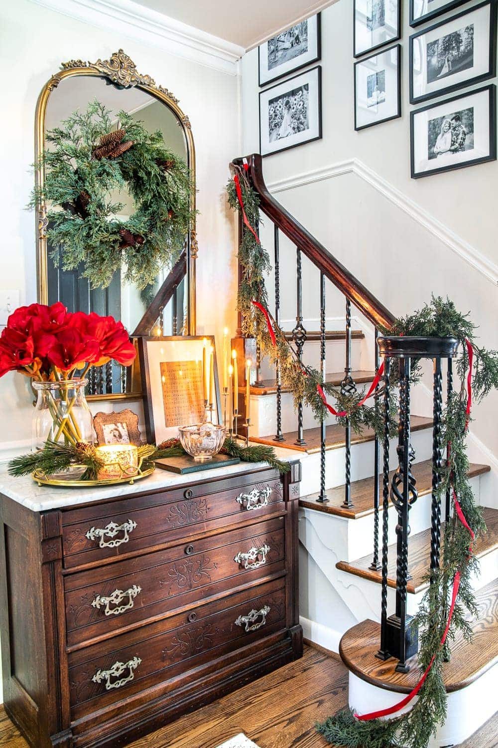 Christmas decor ideas | Modern meets traditional Christmas foyer with red amaryllis and real looking faux garland