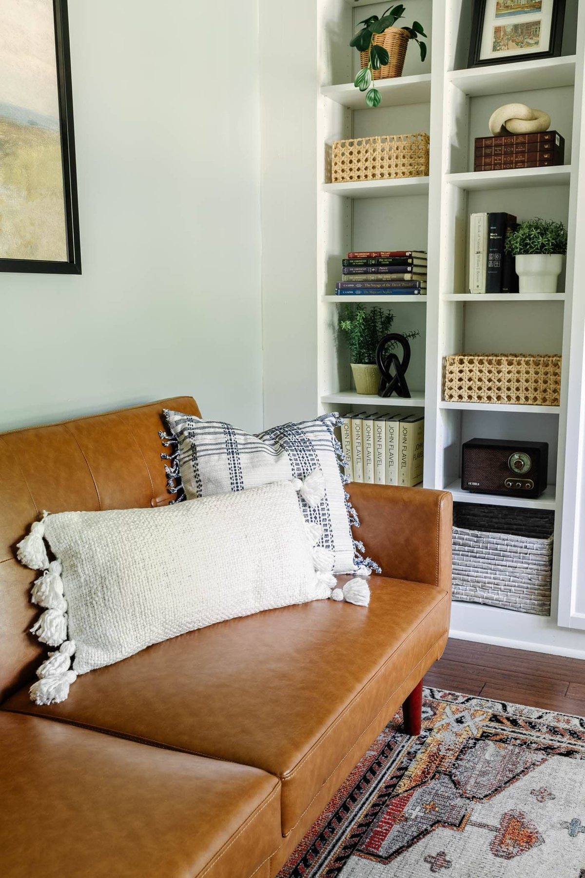 Walmart faux leather futon reading nook with IKEA built-in office shelving