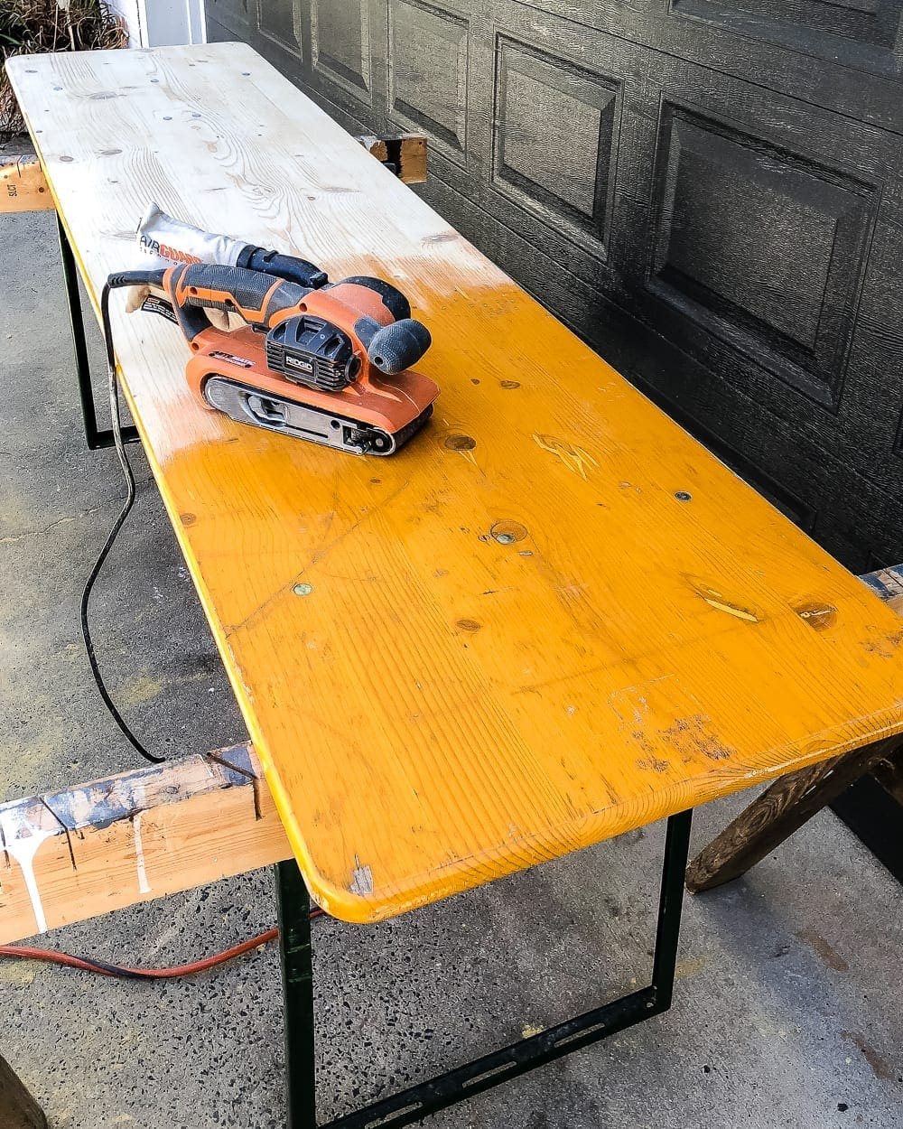sanding down a folding table for refinishing
