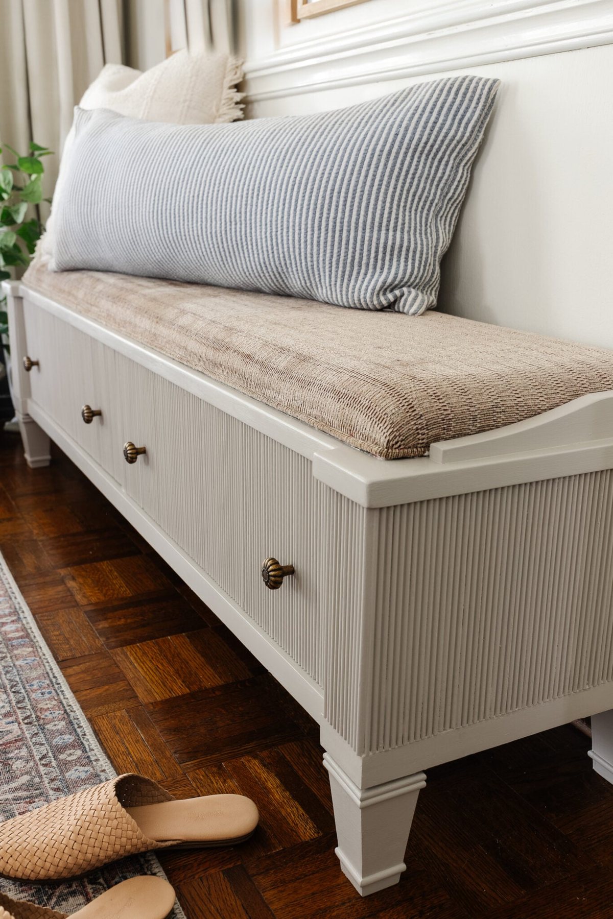 decorative reeding added to a storage bench in an entryway and painted Sherwin Williams Anew Gray