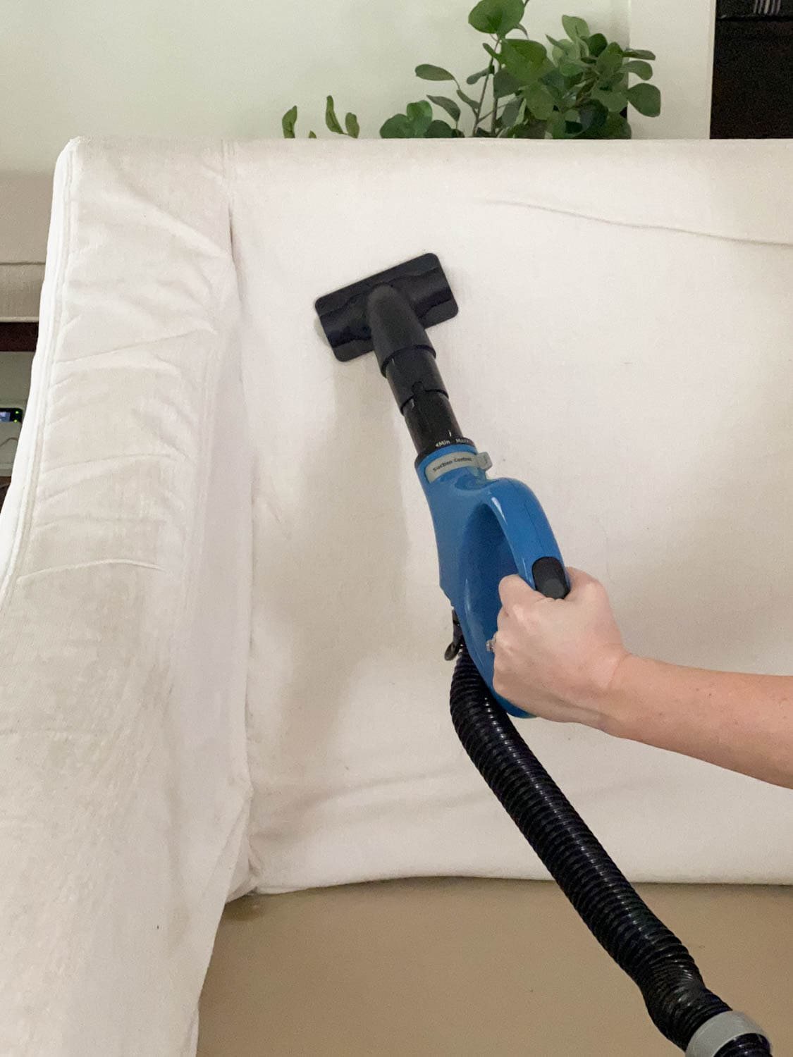 cleaning upholstery with a vacuum wand attachment