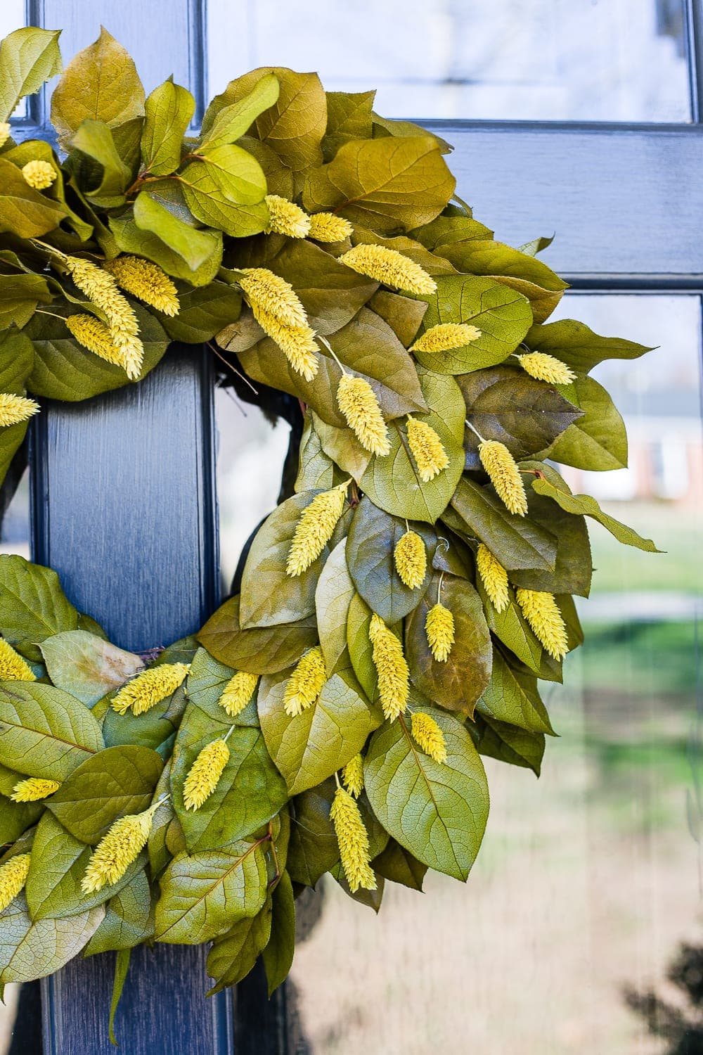 4 easy steps to decorate a small porch stoop for spring to make any home more welcoming for guests. #springporch #smallporch #porchstoop